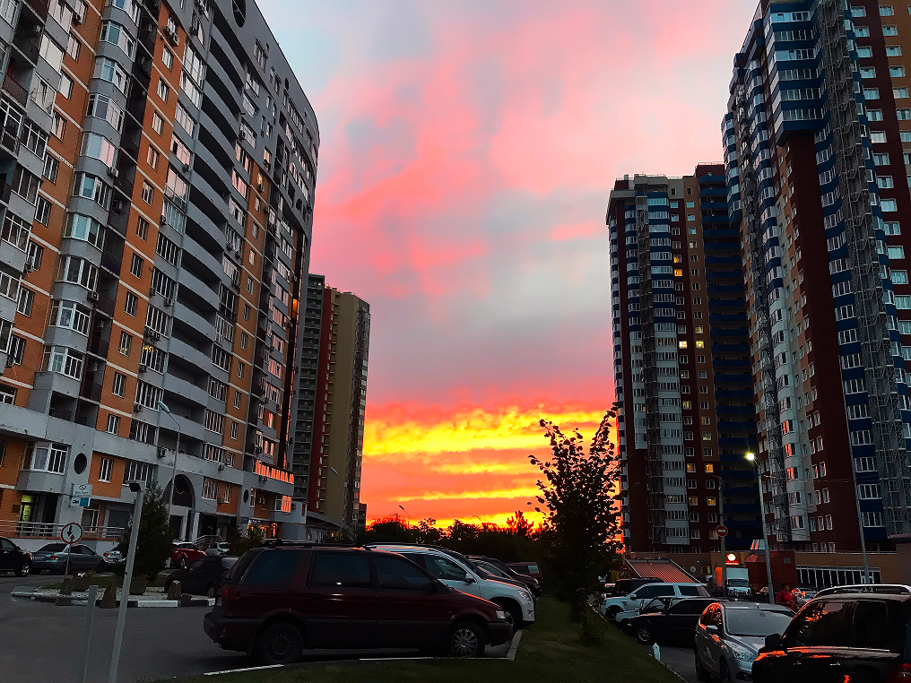 Pink sunset between high-rise apartment buildings on a New York street
