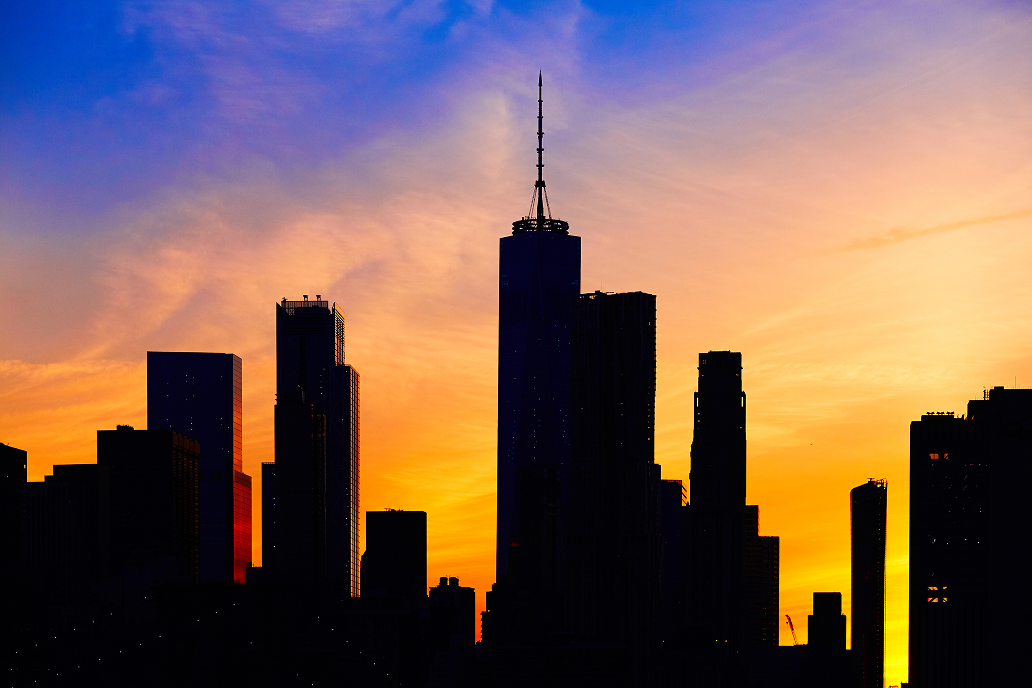 Silhouette of the One World Trade Center skyline at sunset