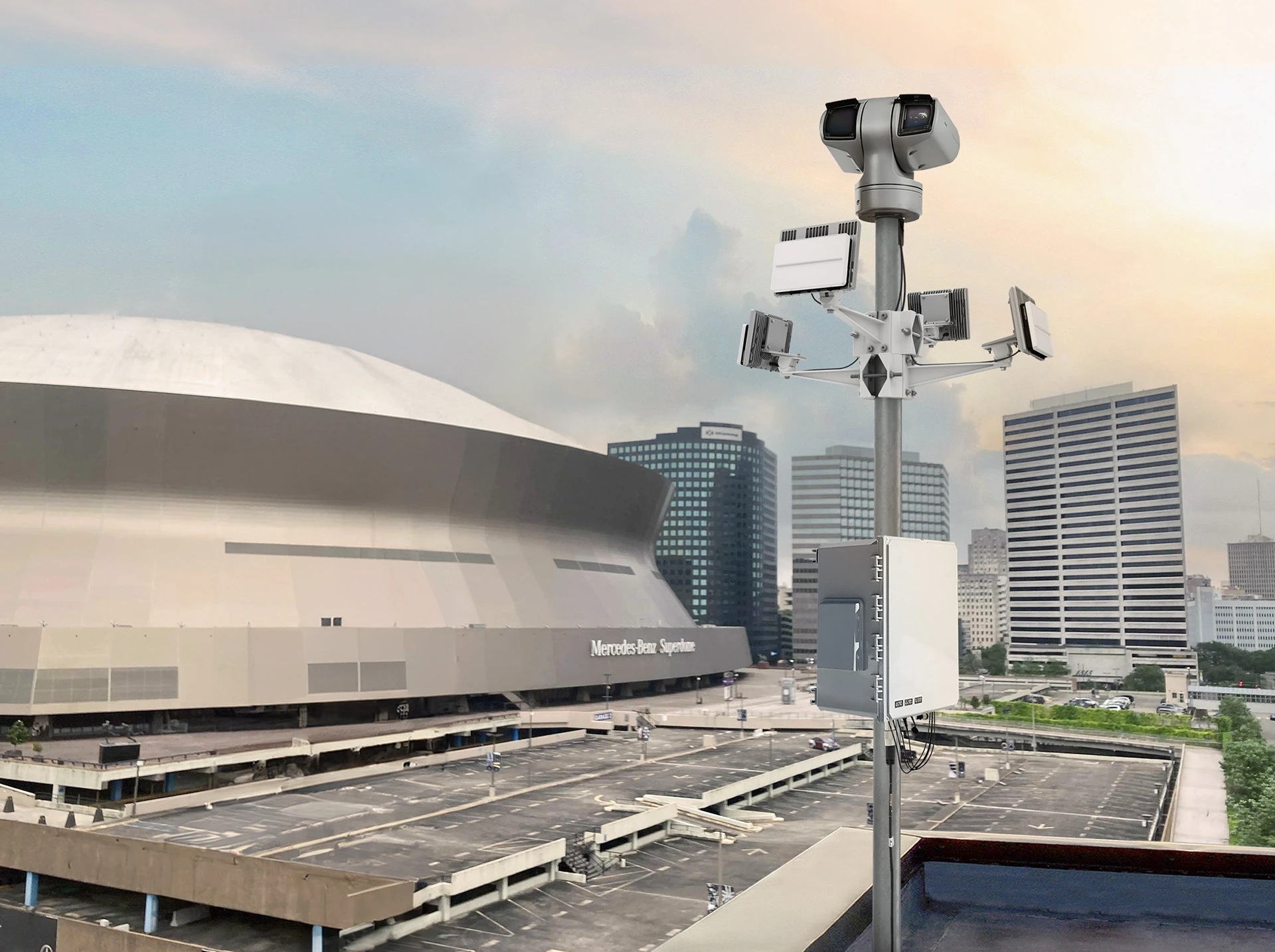 echoGuard radars mounted on a tall pole overlooking a large parking lot and the Mercedes-Benz Superdome stadium with city buildings in the background.