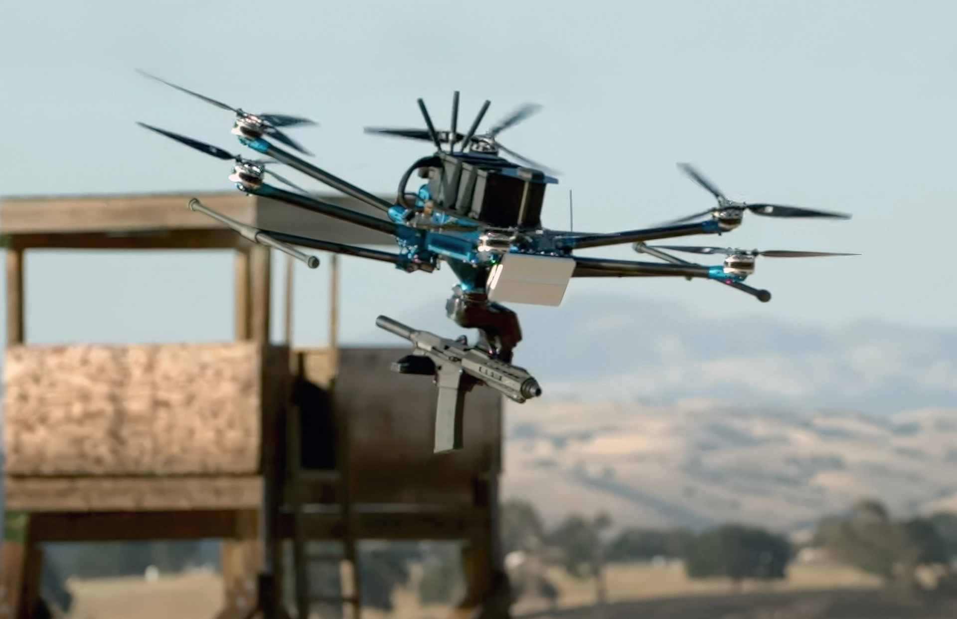 A EchoFlight drone equipped with a mounted firearm flying near a wooden structure in an outdoor setting.