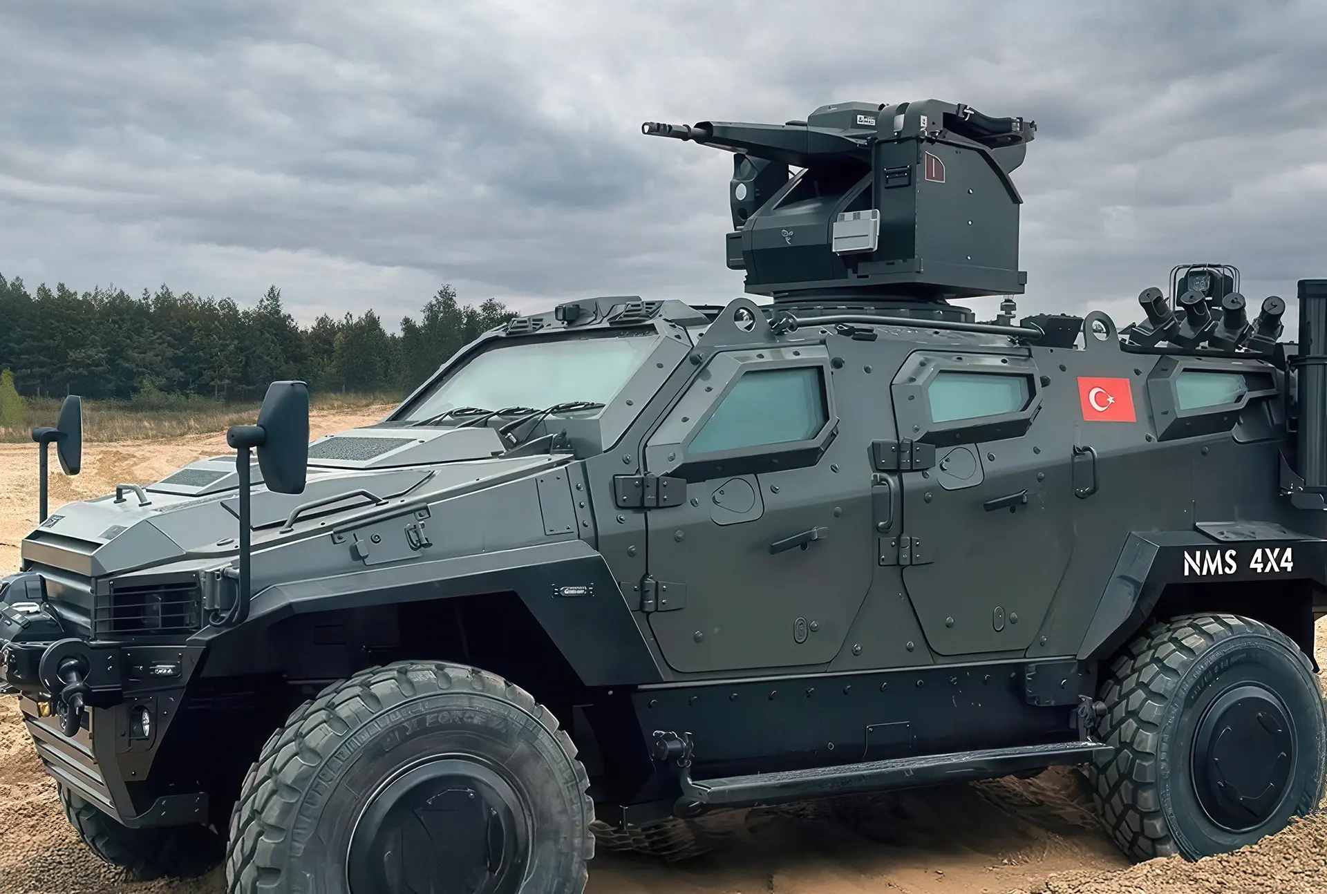 Armored military vehicle with mounted EchoGuard radar and Turkish flag on the side, parked on a dirt road under cloudy sky.