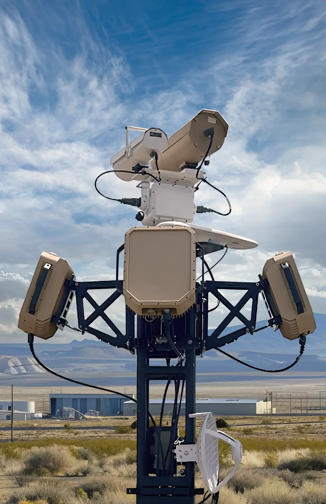 Weather monitoring station with sensors and antennas under a partly cloudy blue sky.