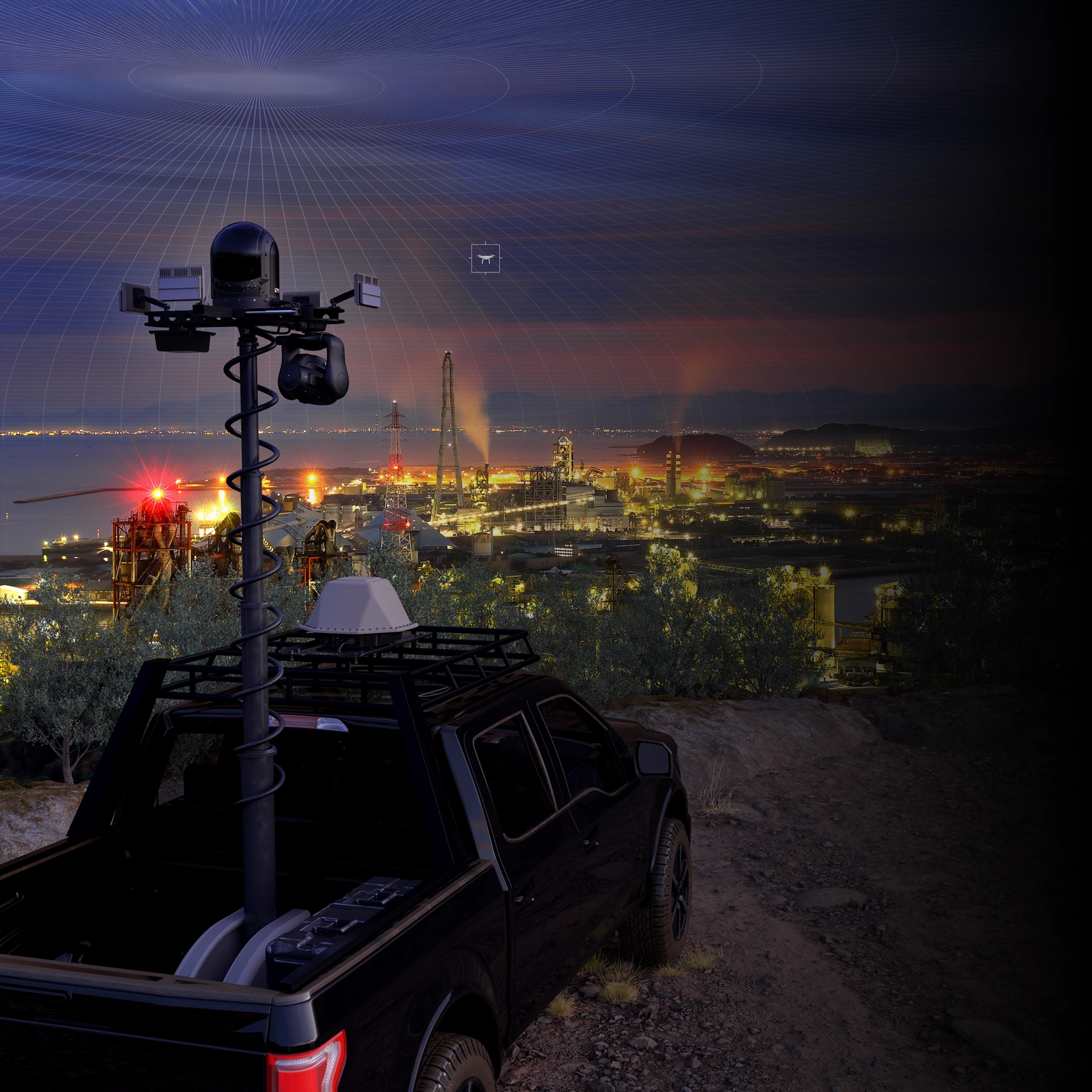 Black truck with radar and cameras overlooks industrial plant lit up at dusk with smoke stacks glowing.