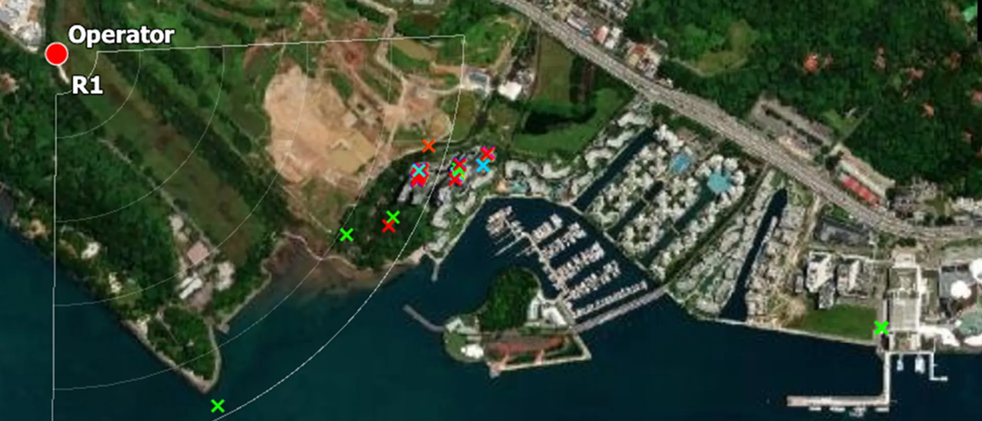 Aerial map showing a coastal area with buildings, water, and marked red and green points around an 'Operator' label.