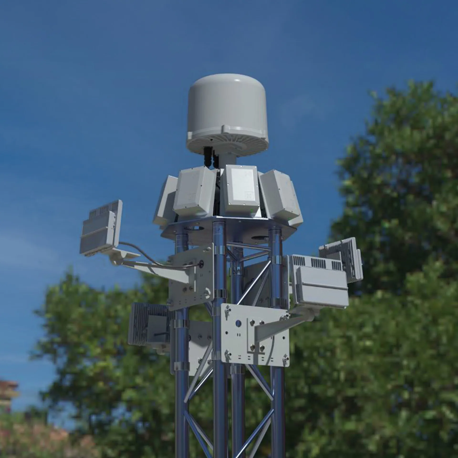 Tall metal tower mounted with various white electronic devices and sensors against a blue sky.