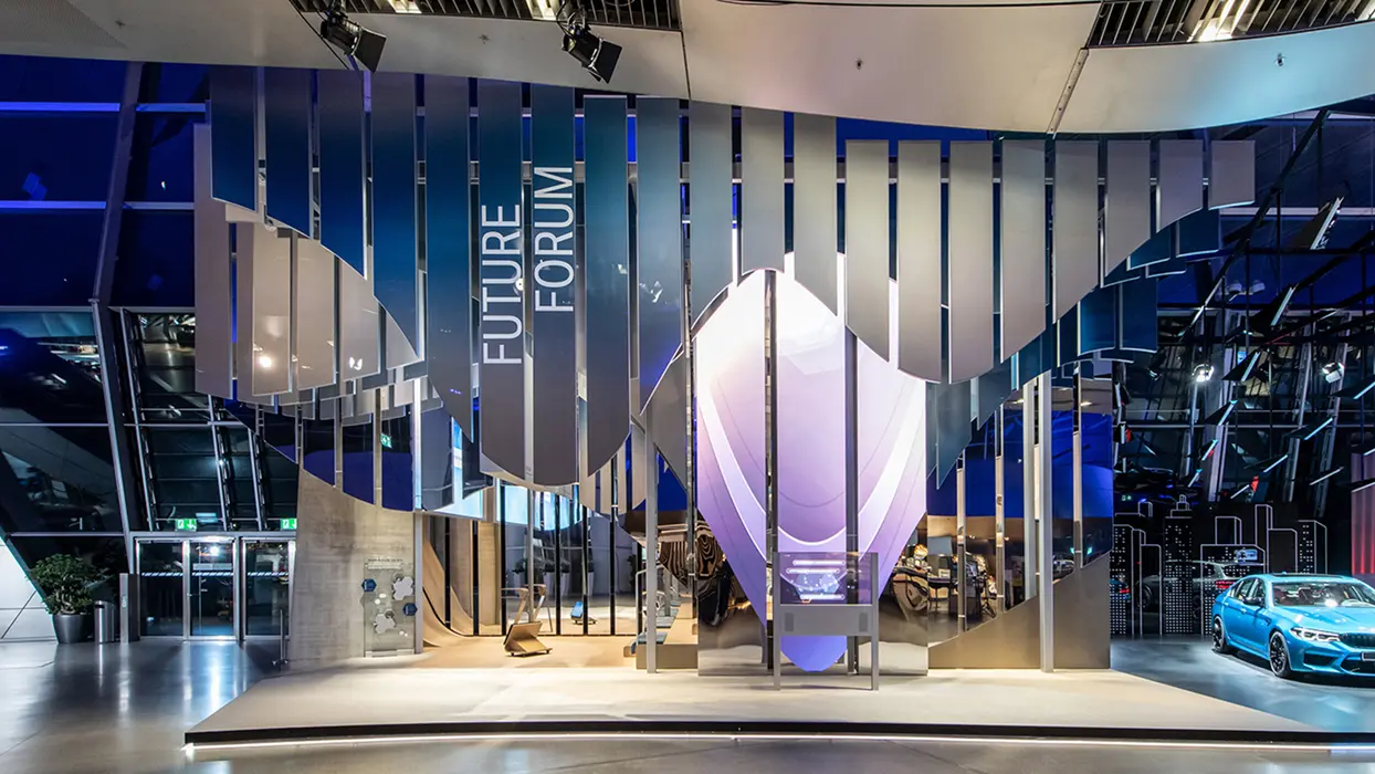 AV installation with vertical display surfaces and an illuminated droplet shape at the BMW Future Forum.