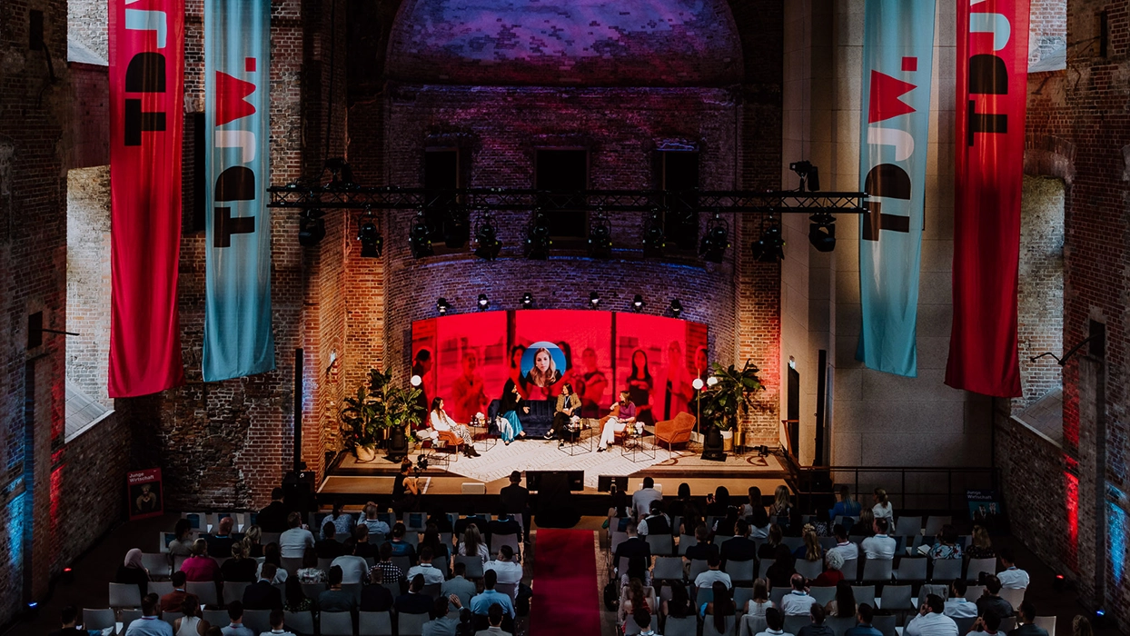 A group in a room with red banners