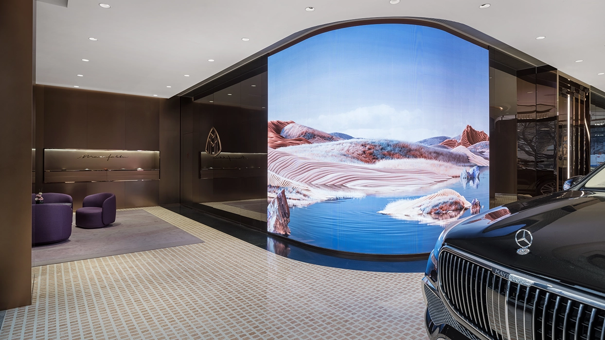 Luxury car dealership with a large painting