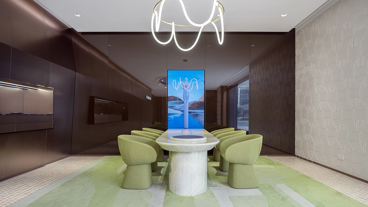 Green chairs beneath a chandelier