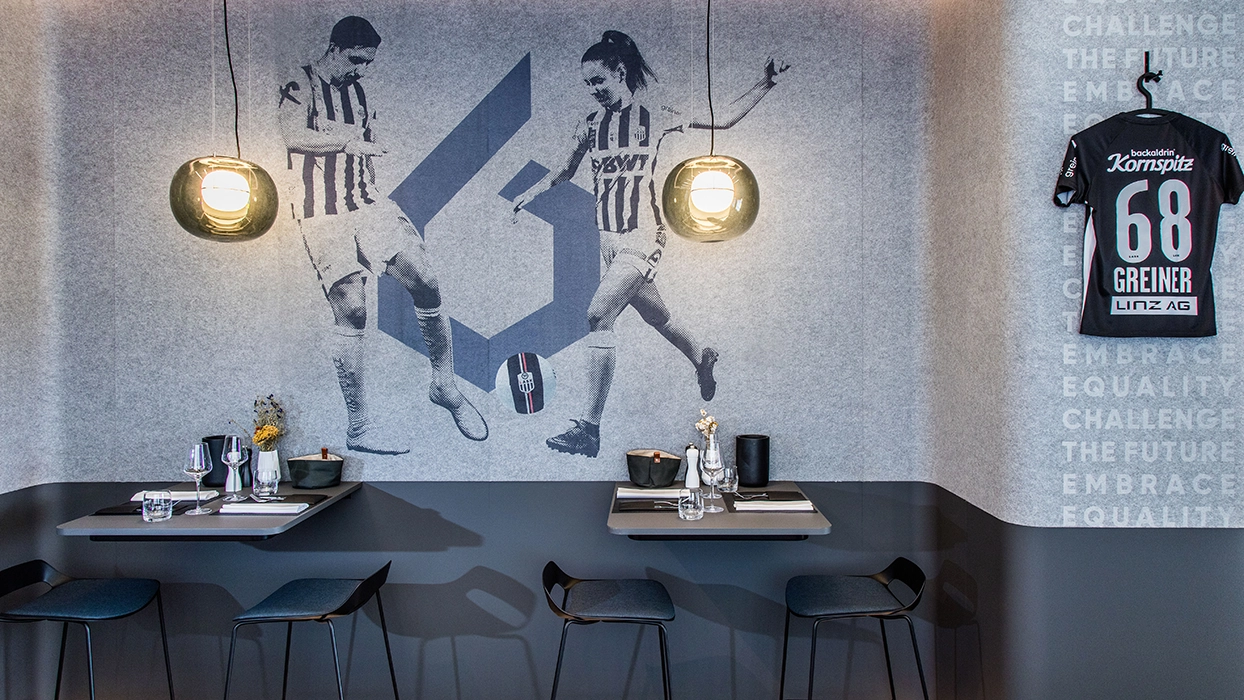 A restaurant with a mural of a football team on the wall.