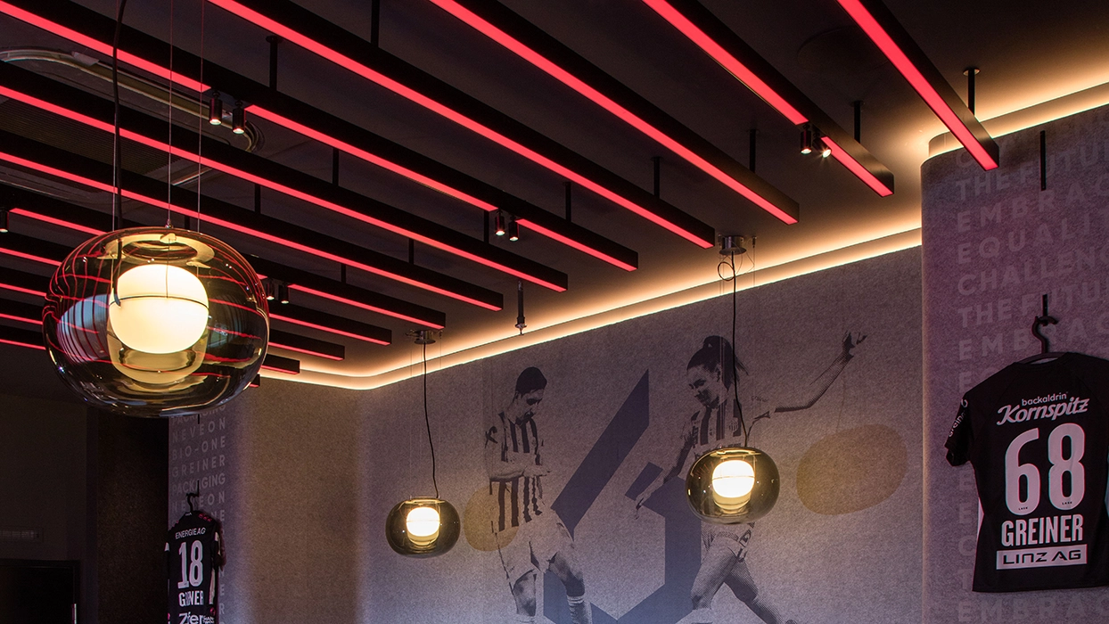 A restaurant interior decorated with red lights and posters.