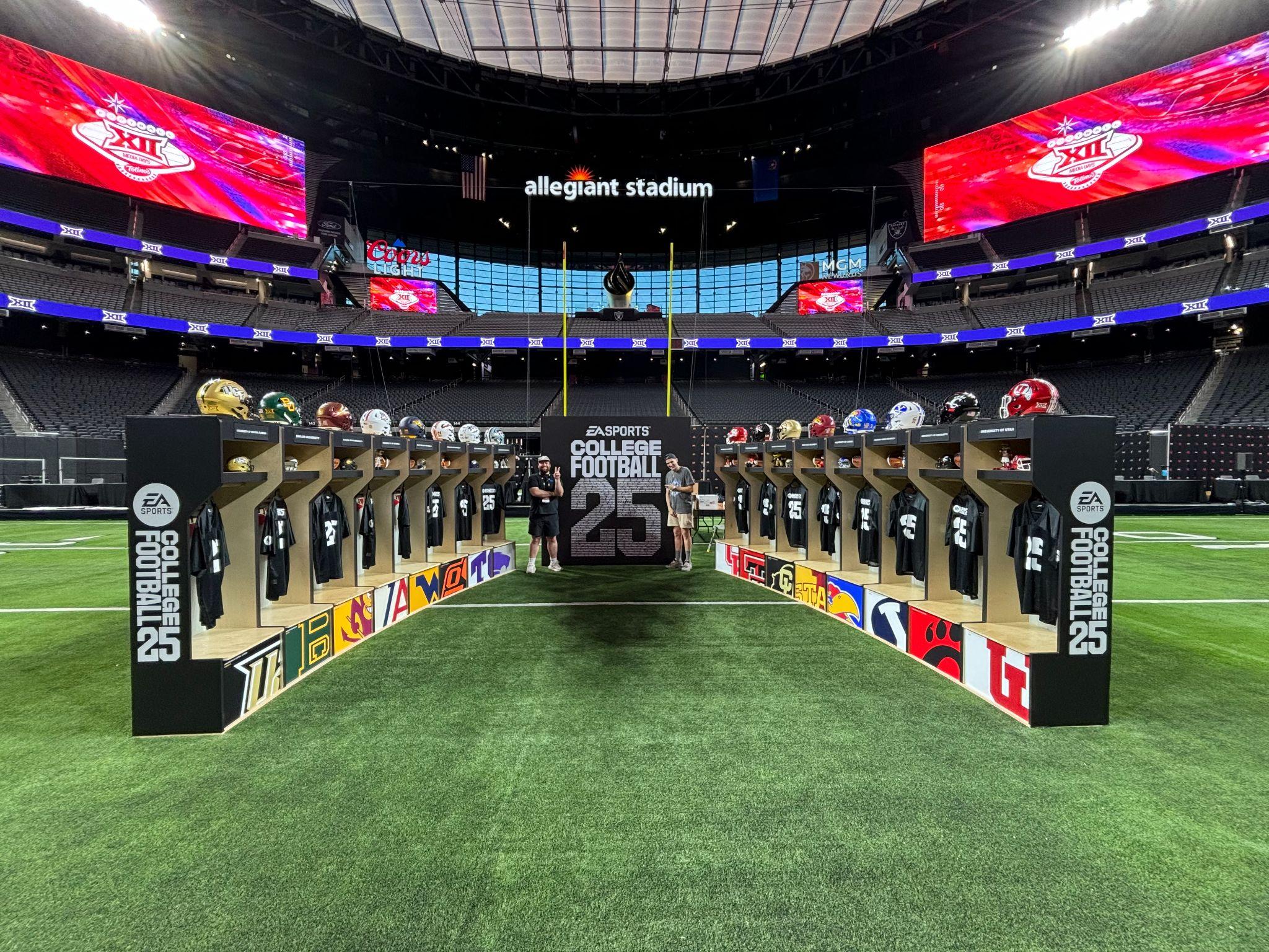 EA Sports College Football 25 locker display with school jerseys and helmets on the field at Allegiant Stadium