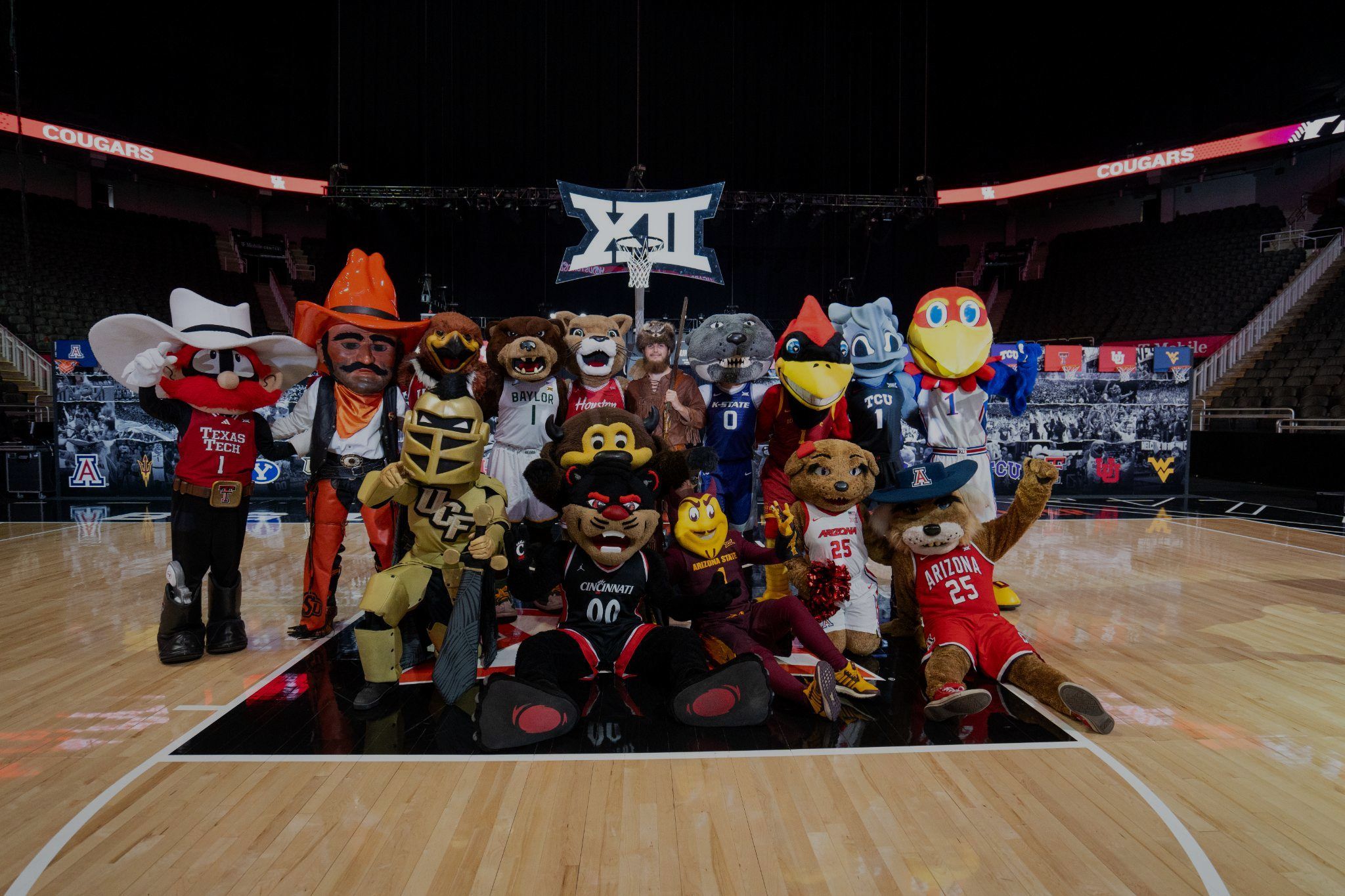 Big 12 school mascots gathered on a basketball court under the Big 12 logo