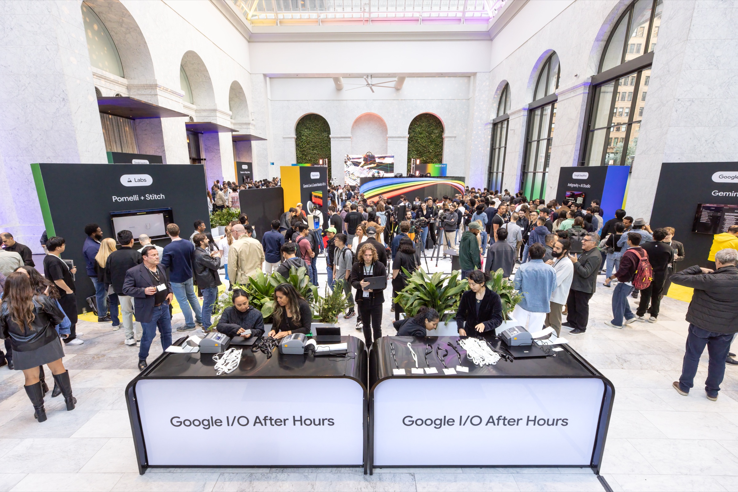 Crowd filling the atrium at One Sansome in San Francisco for Google I/O After Hours, with Google Labs demo stations