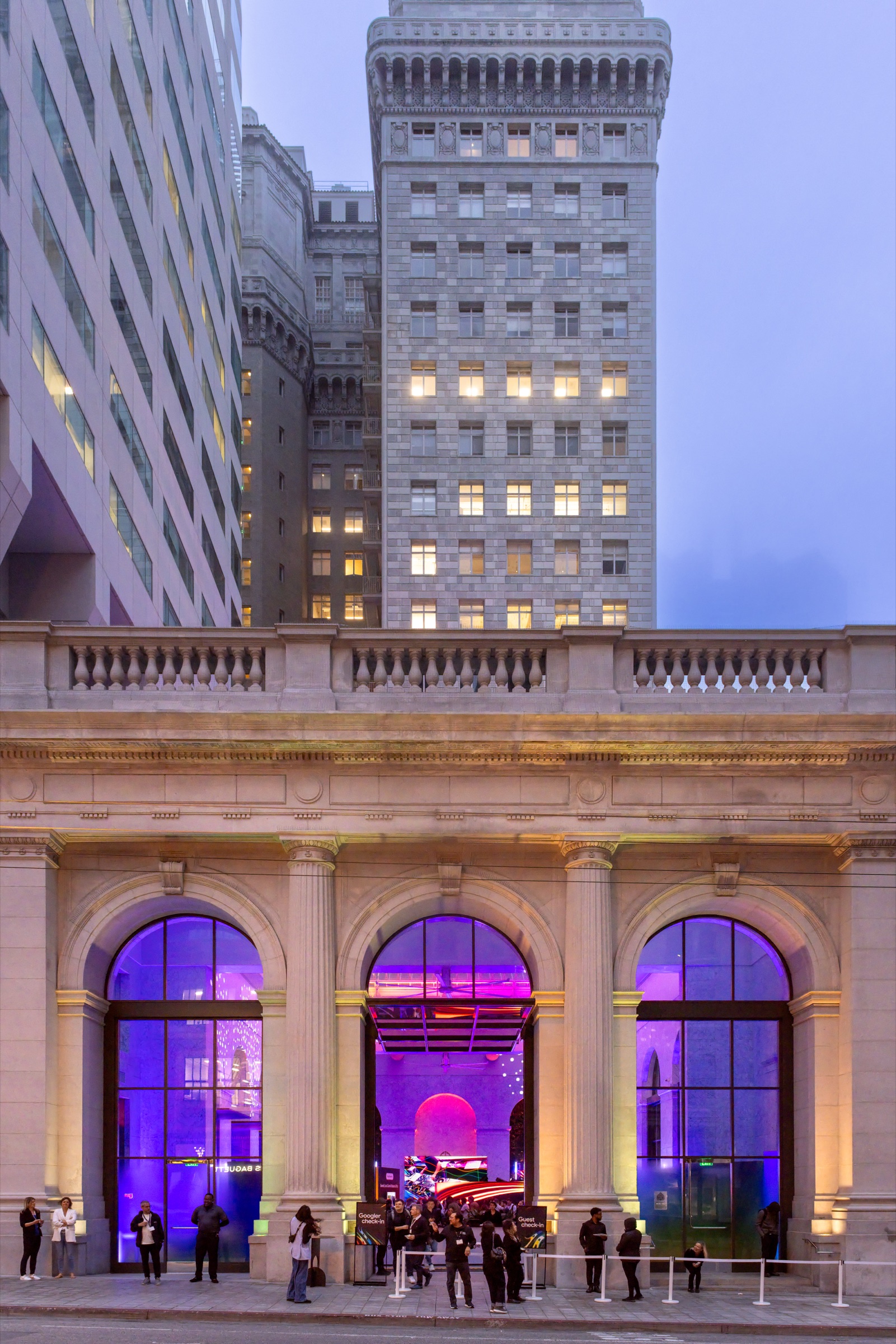 One Sansome's facade lit purple at dusk for Google I/O After Hours in San Francisco