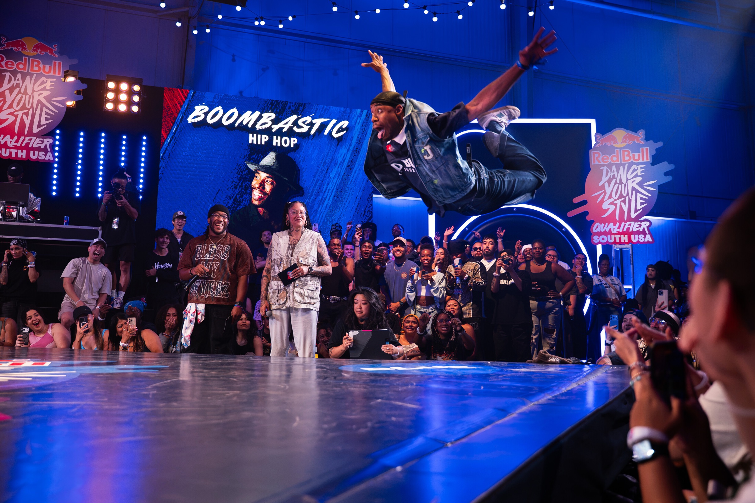 Dancer mid-air in front of the crowd at Red Bull Dance Your Style