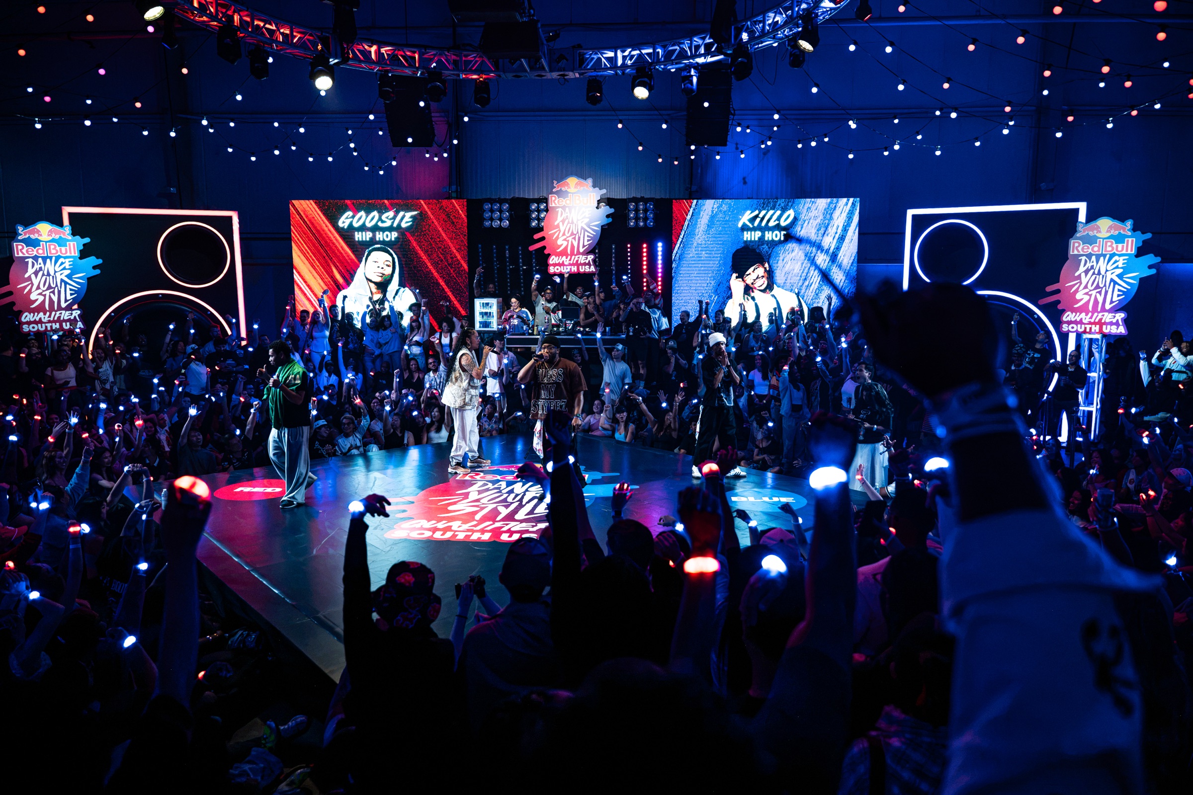 Crowd holding glowing lights around the Dance Your Style battle floor