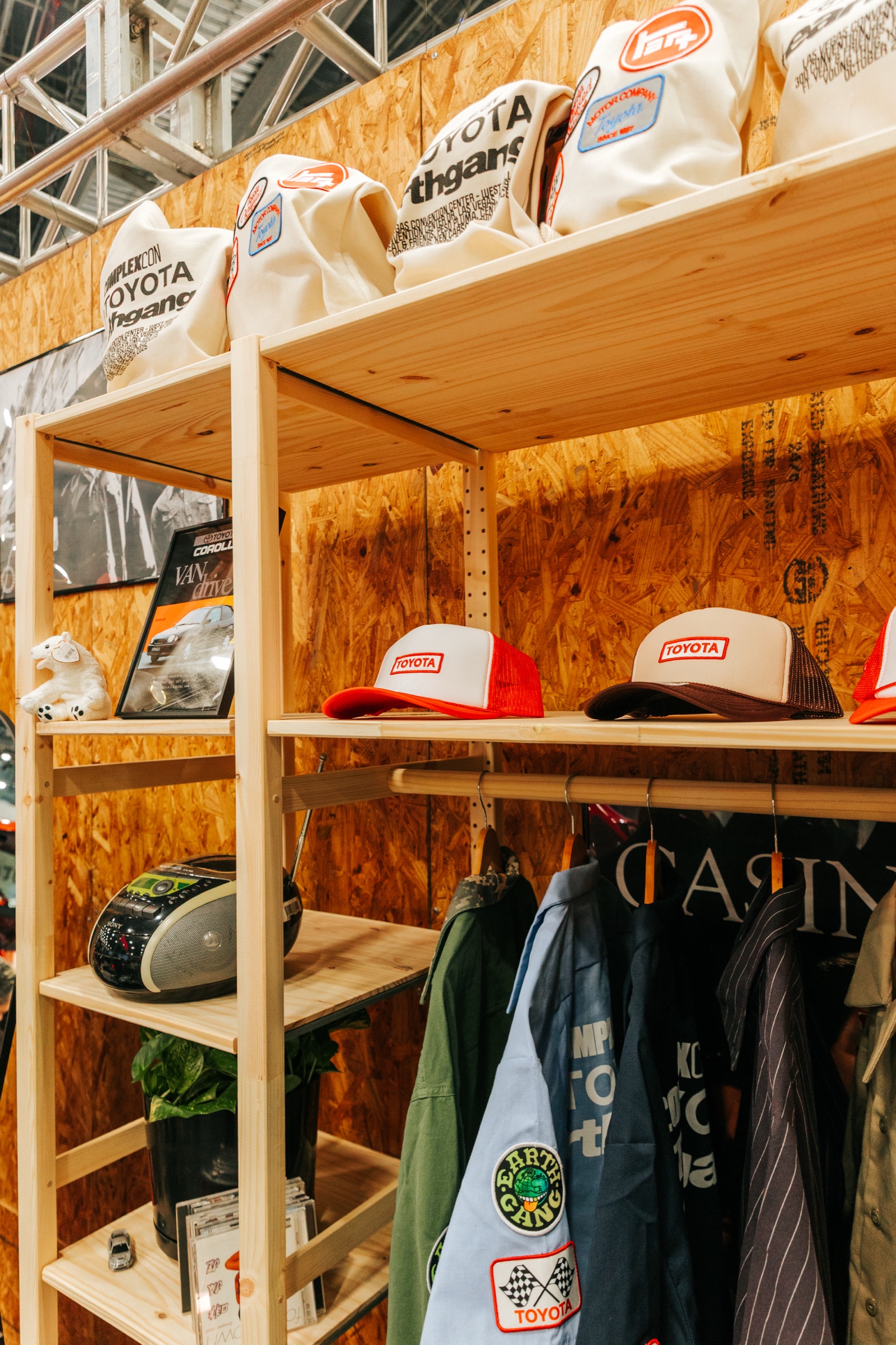 Toyota trucker hats and jackets on plywood garage shelving