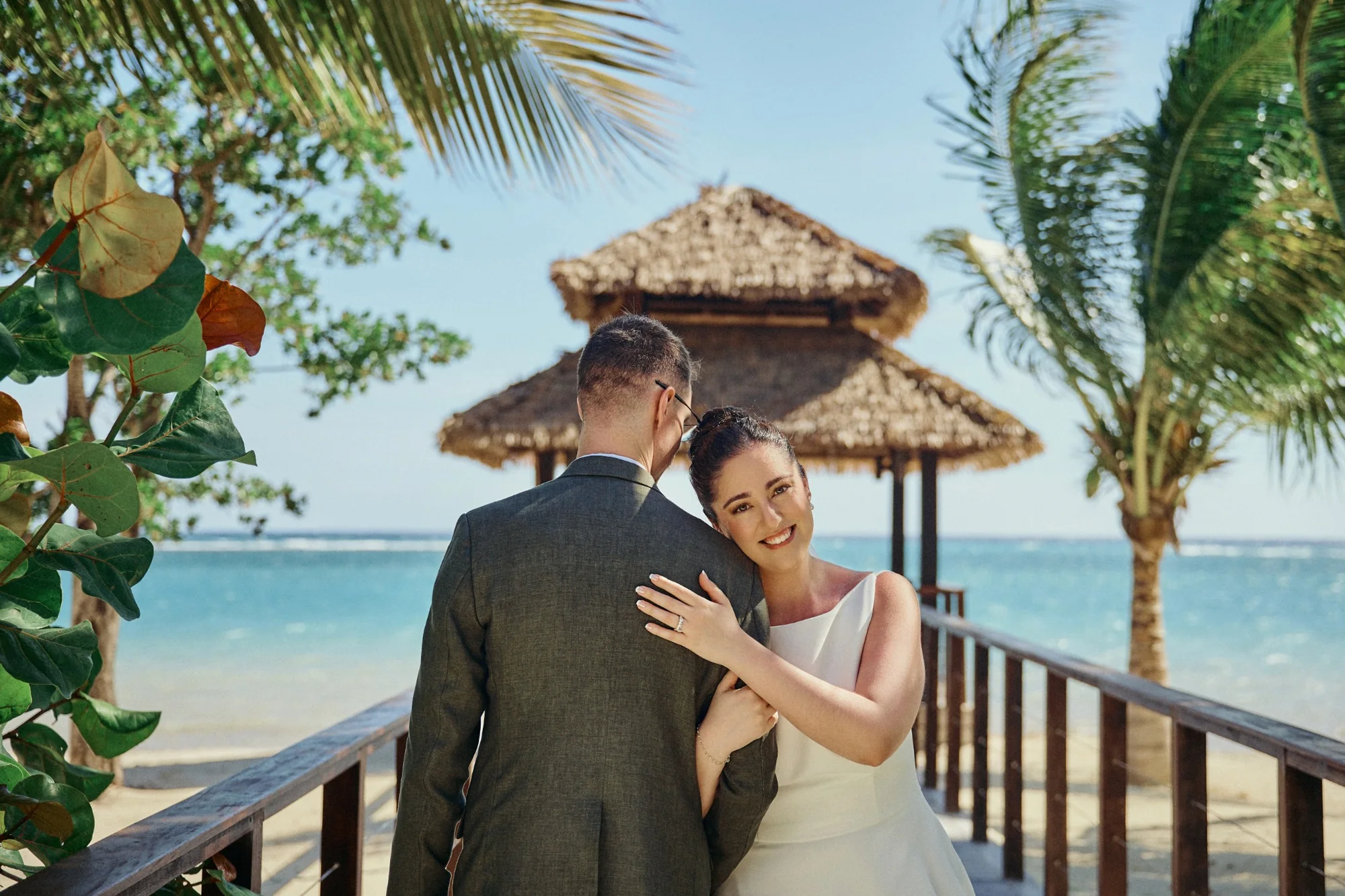 Wedding couple sharing a quiet moment in a tropical garden