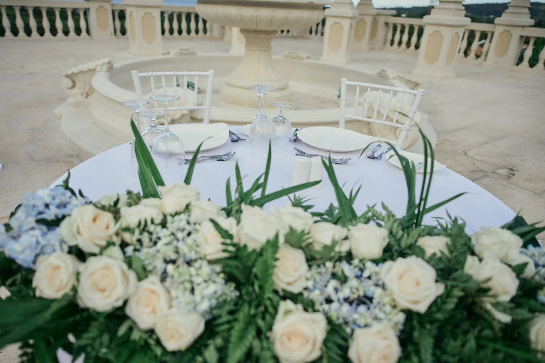 Destination wedding tablescape with tropical florals and ocean views