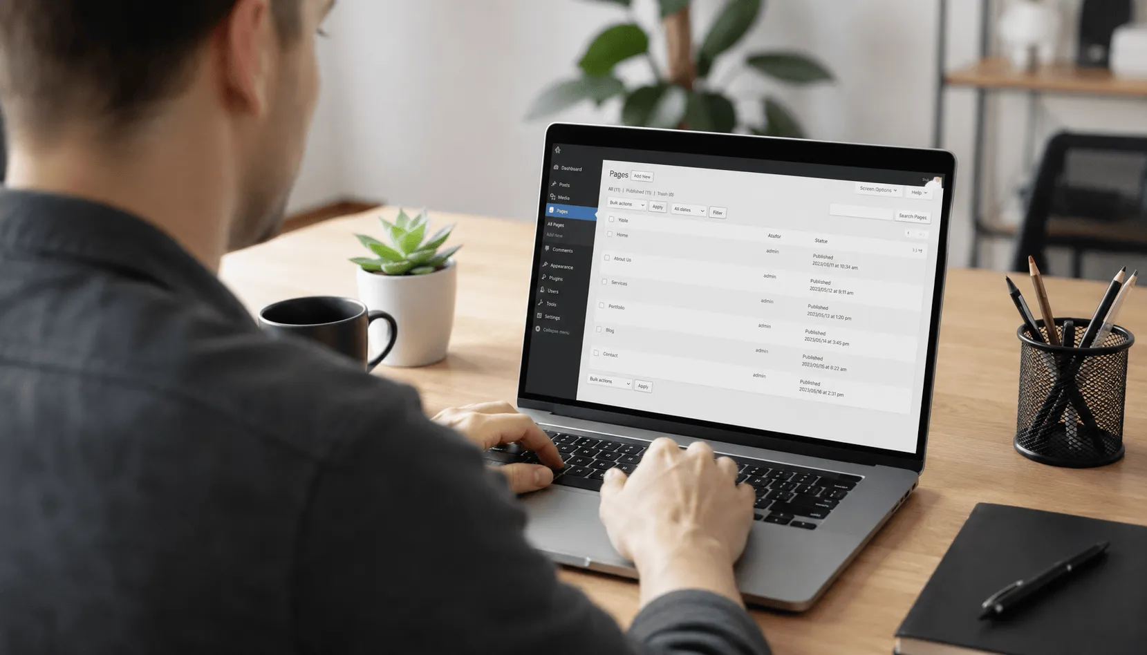Website administrator managing website pages and content on a laptop