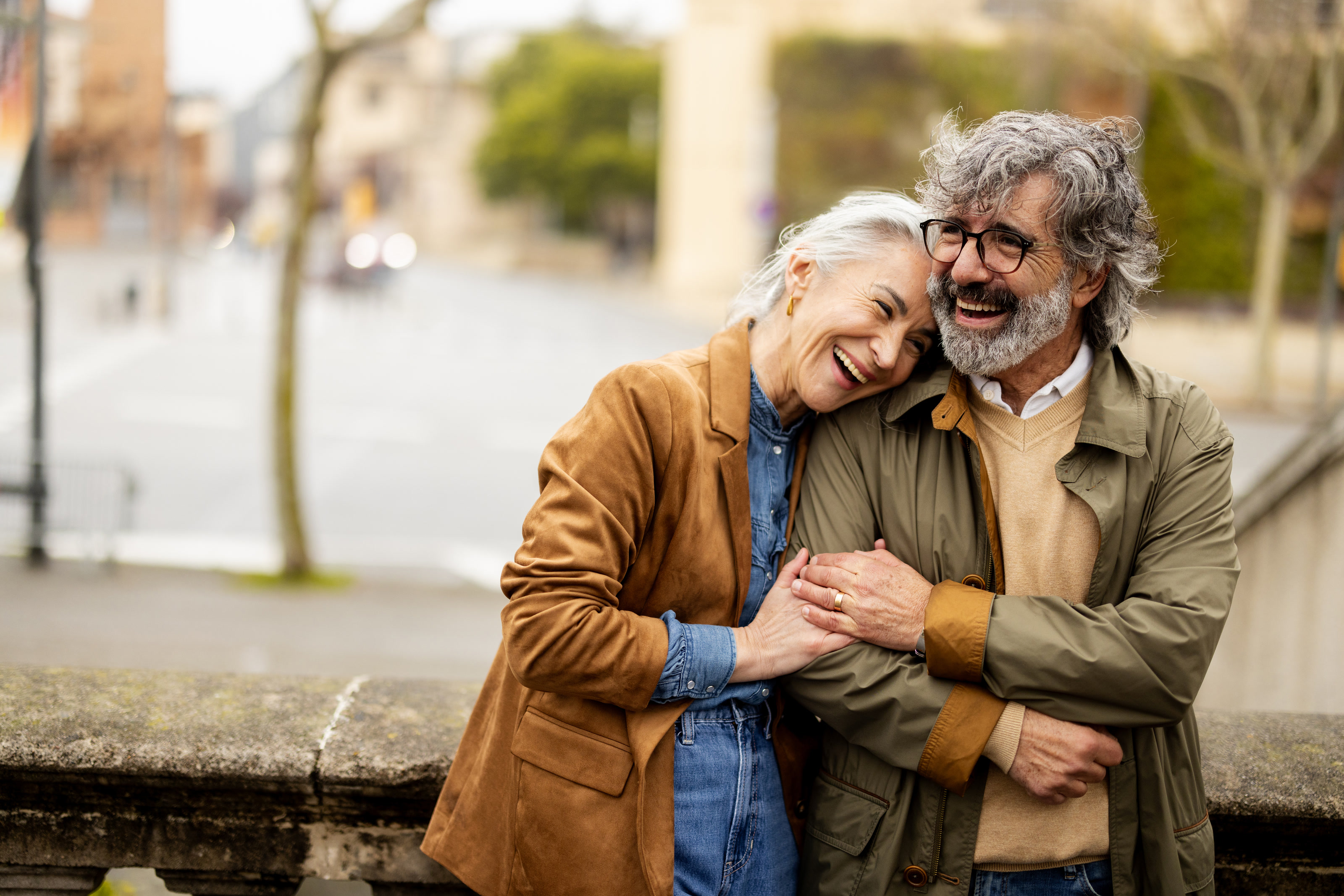 Couple laughing together on a city street
