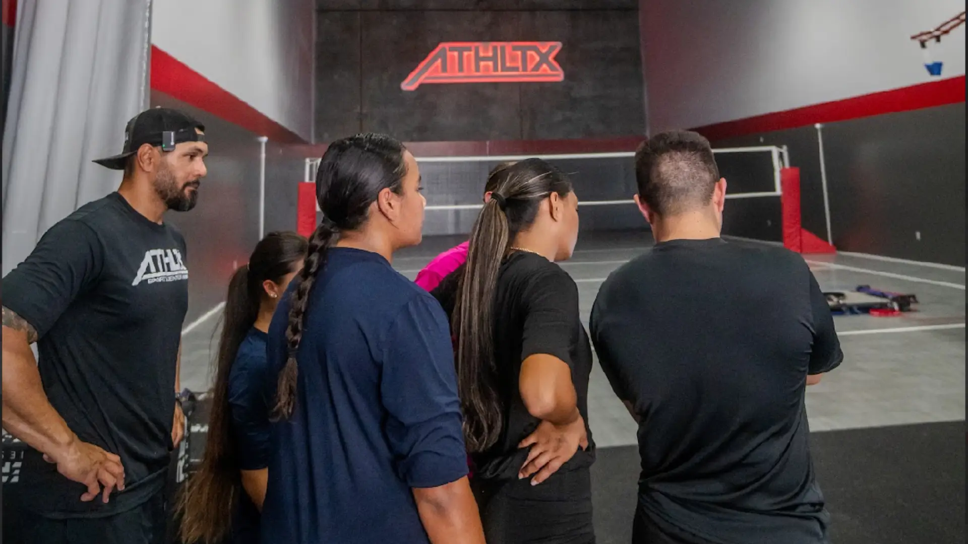 Coaches and athletes gathered on an indoor court at ATHLTX Sports Performance in Waipahu, HI.