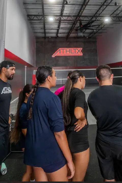 Coaches and athletes gathered on an indoor court at ATHLTX Sports Performance in Waipahu, HI.