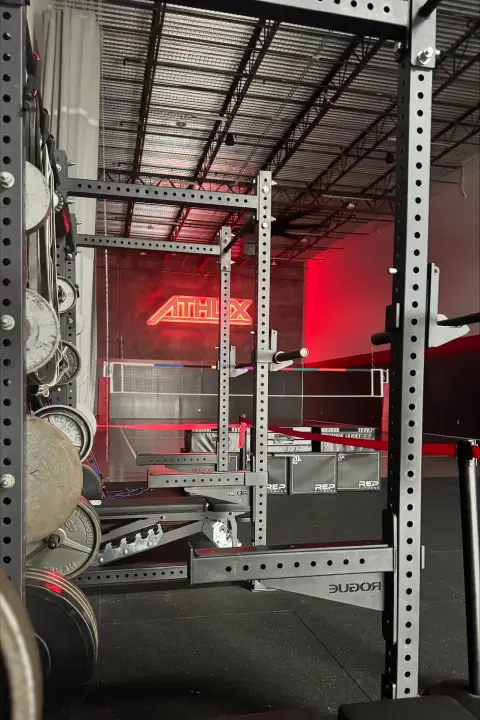 Strength training equipment and weight racks inside ATHLTX Sports Performance in Waipahu, HI.