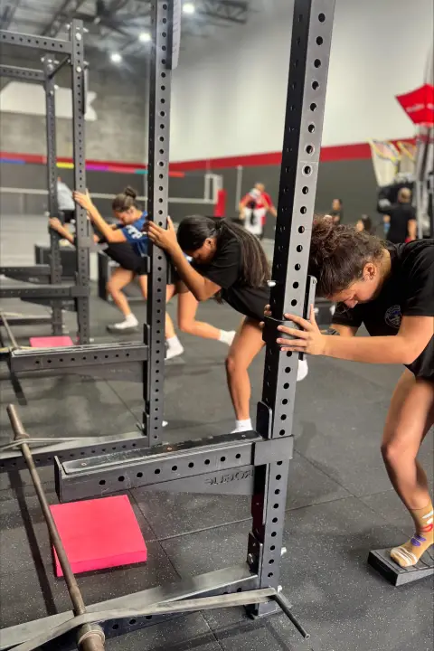 Young athletes performing mobility and injury prevention exercises at ATHLTX Sports Performance in Waipahu, HI.