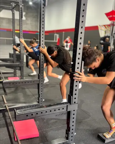 Young athletes performing mobility and injury prevention exercises at ATHLTX Sports Performance in Waipahu, HI.