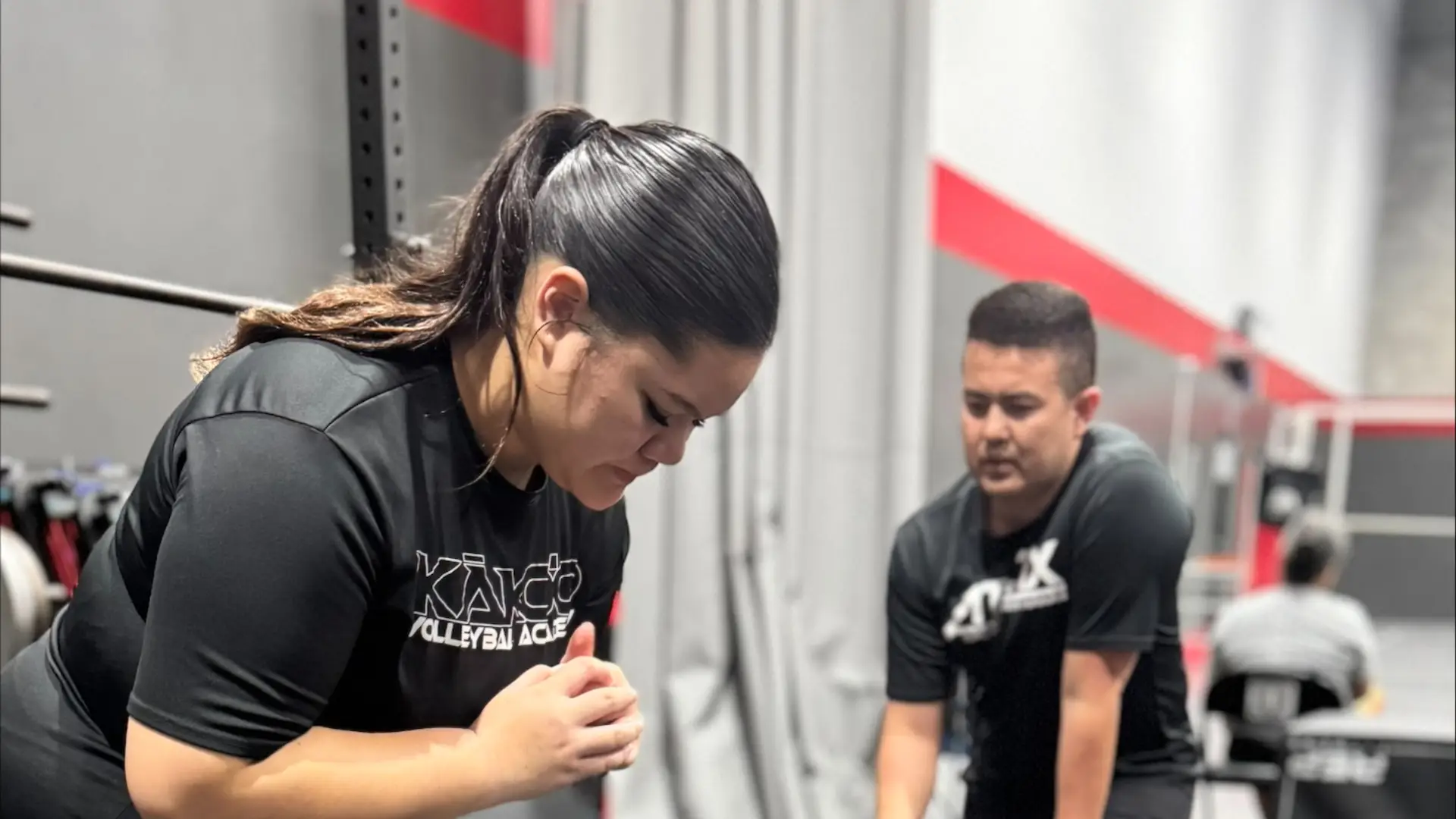 Athlete performing a strength and conditioning exercise with a coach at ATHLTX Sports Performance in Waipahu, HI.