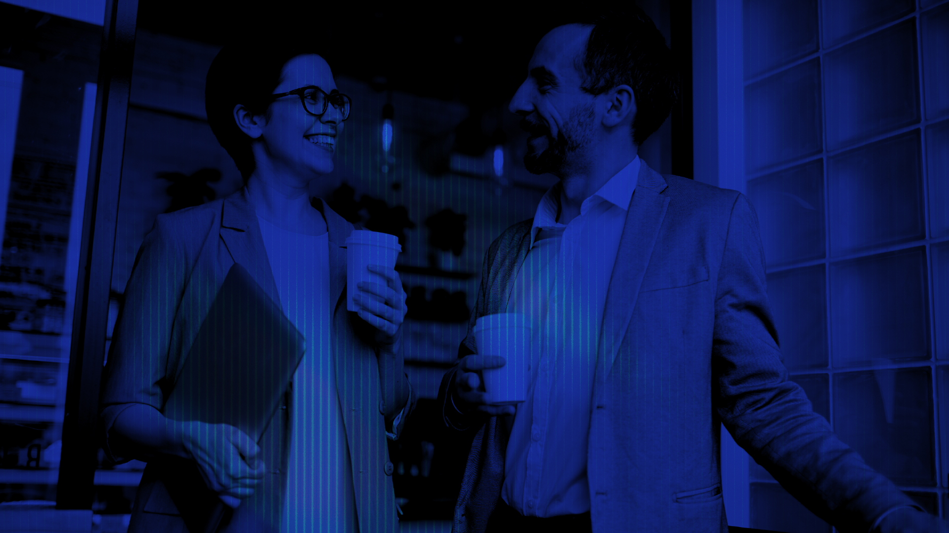 Two people talking over coffee