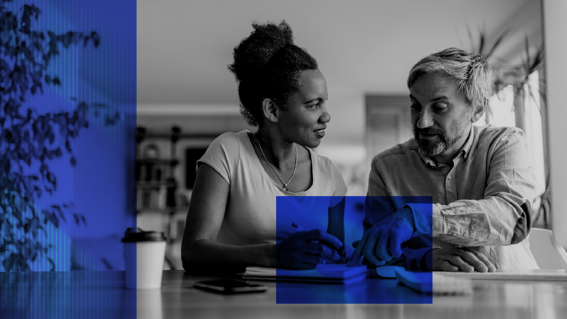 Two people reviewing loan balances at a table