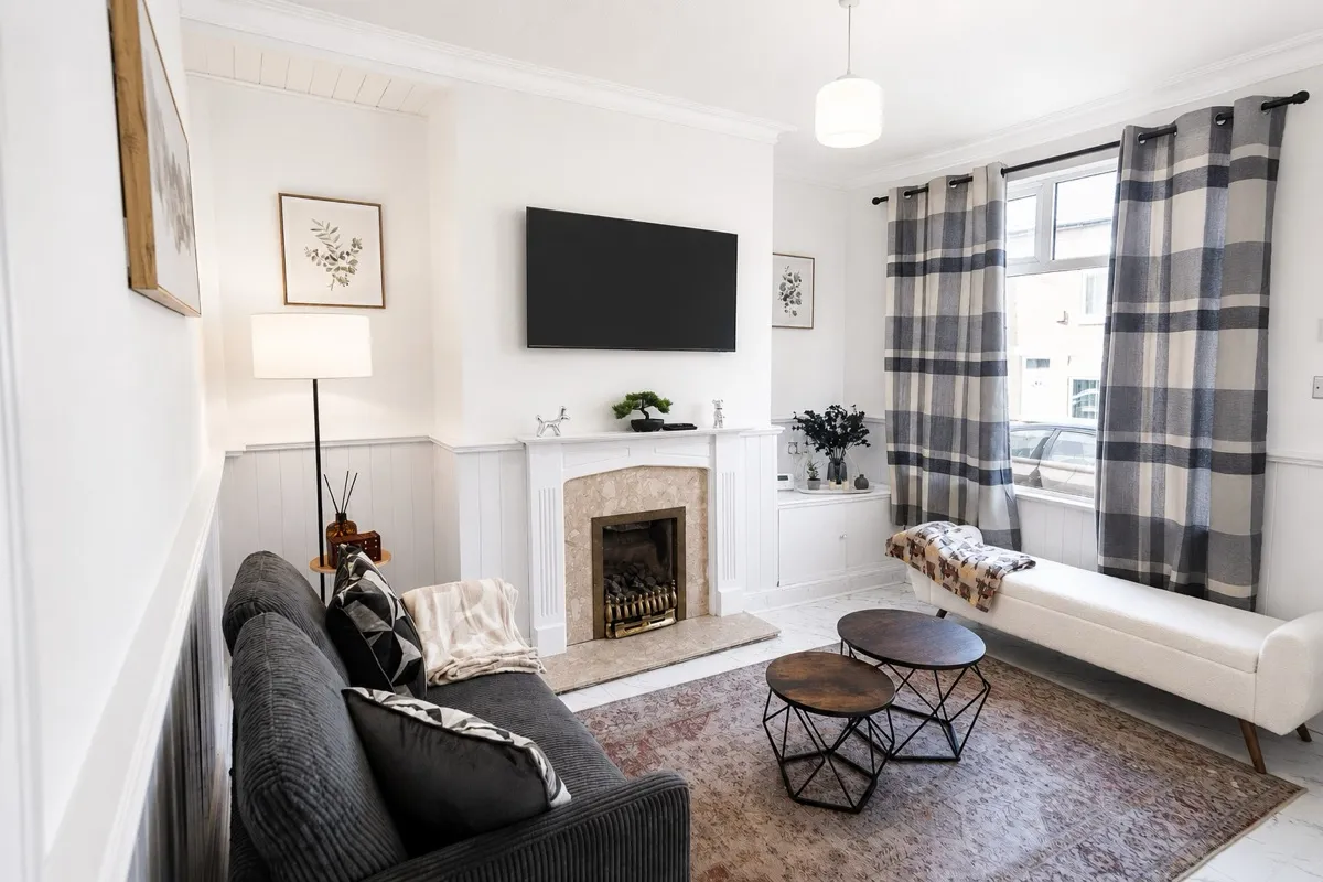 A styled front lounge with panelled walls in a Manchester short-let managed by Kammili Properties