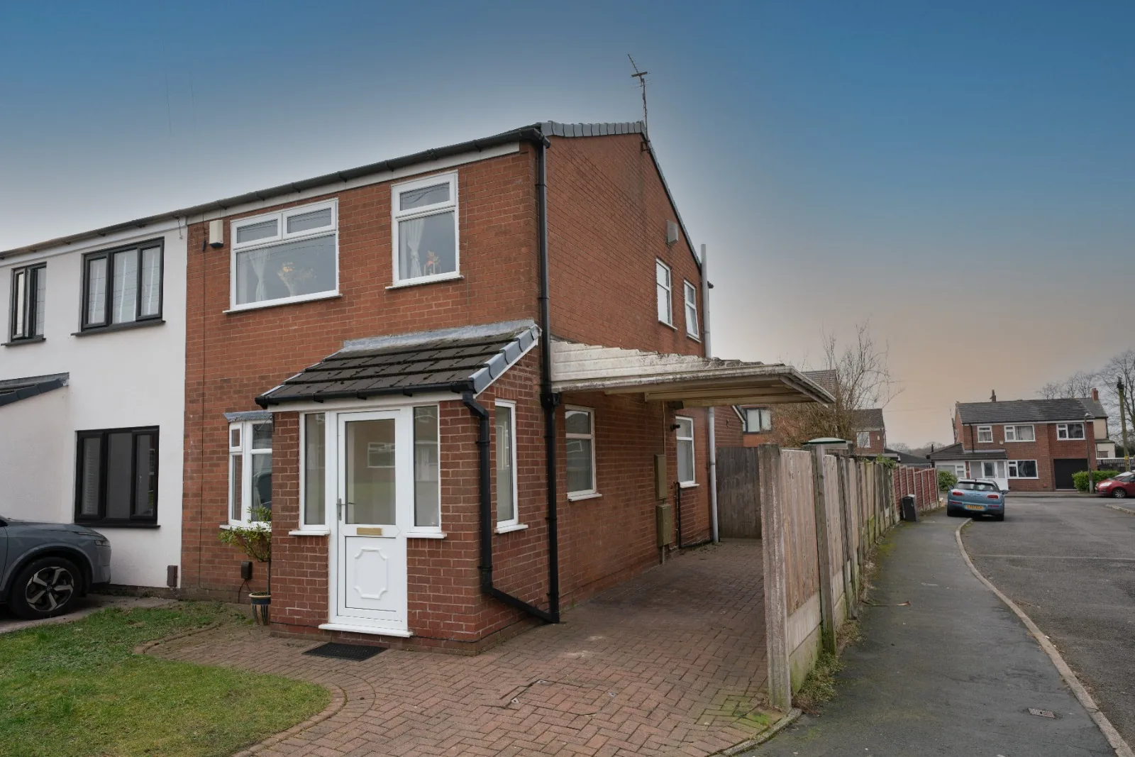 The red-brick exterior and driveway at Old Vicarage, a short-let in Westhoughton, Bolton