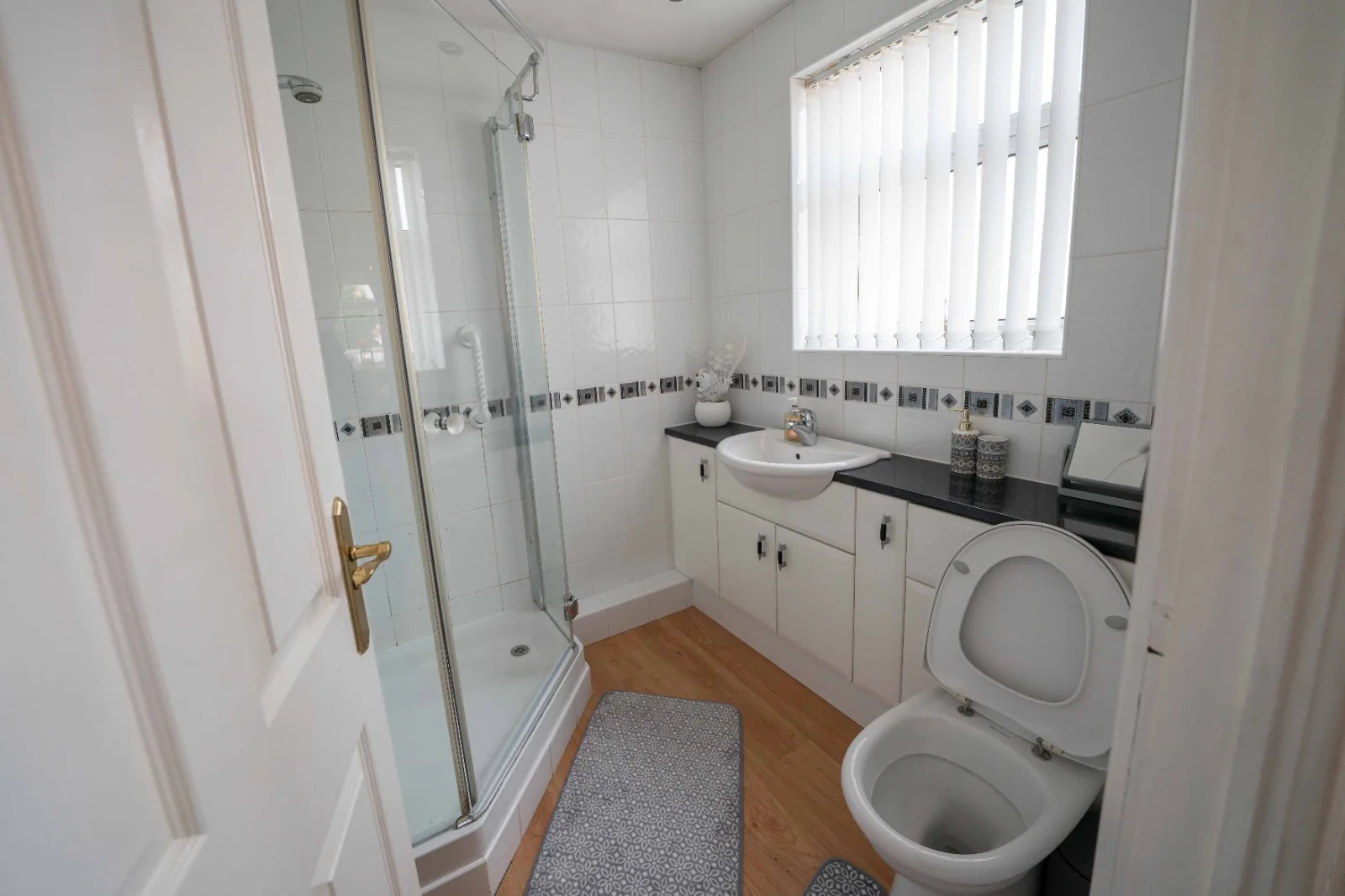 Shower room with corner shower and vanity unit at Old Vicarage in Westhoughton, Bolton