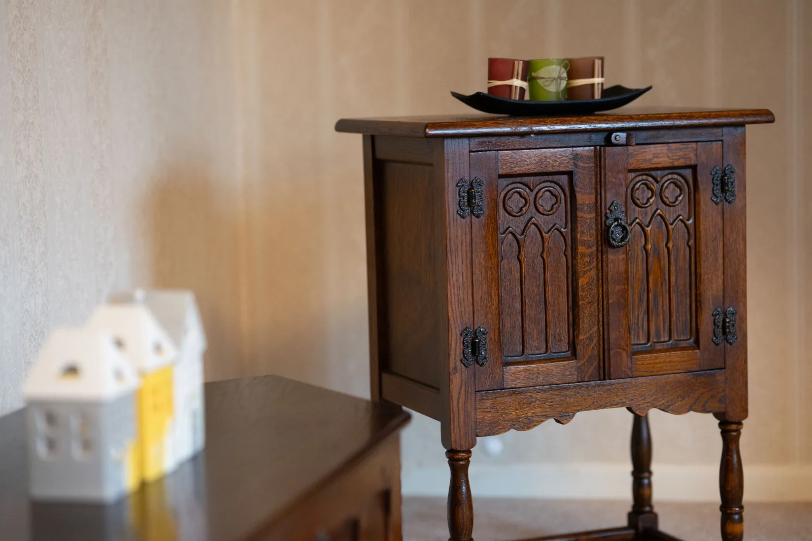 Carved oak side cabinet detail in the living space at Old Vicarage in Westhoughton, Bolton