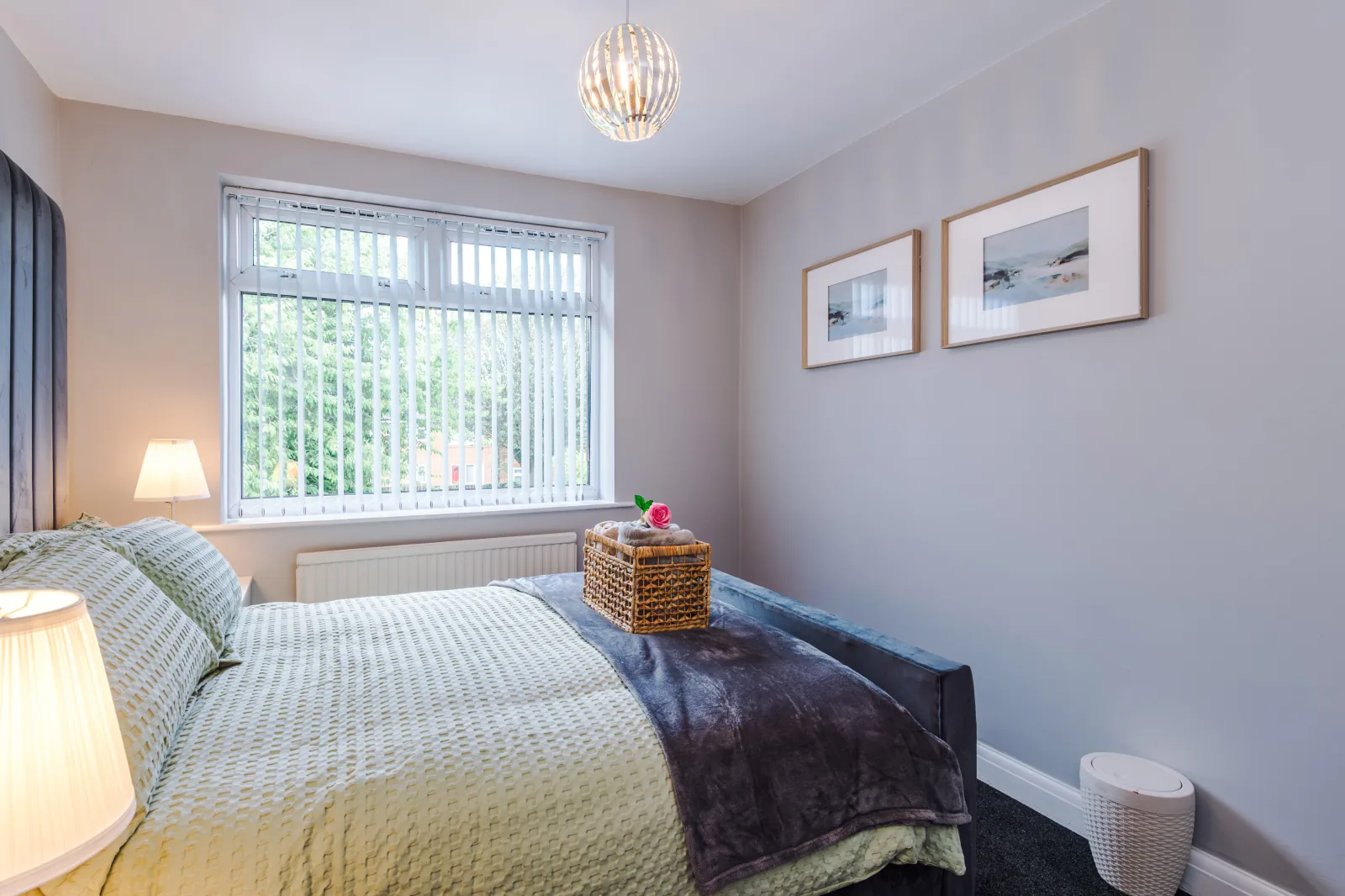 Second bedroom with sage green bedding and a garden-facing window at 3 Albert Gardens