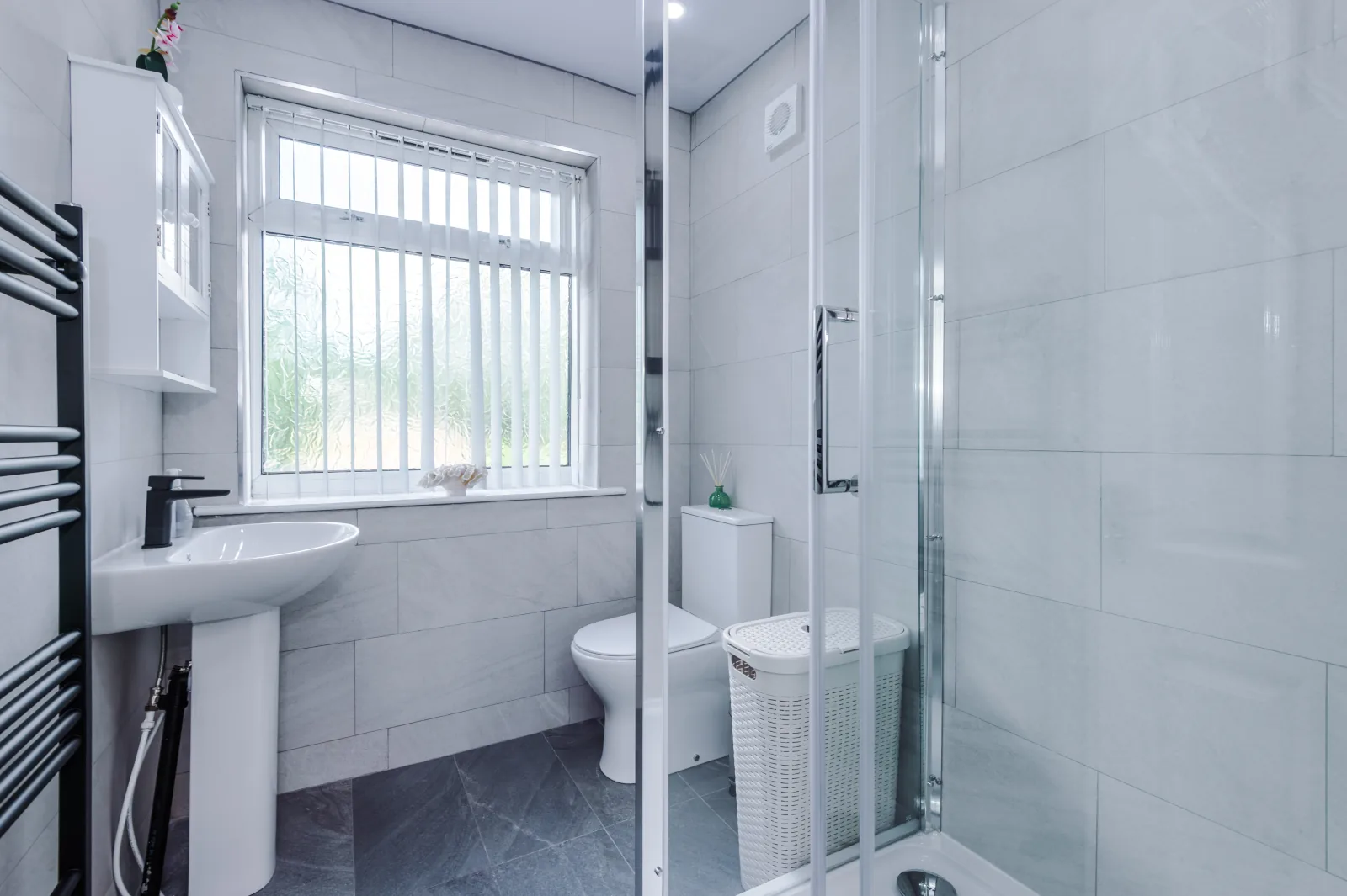 Bathroom with a corner shower enclosure and window at 3 Albert Gardens