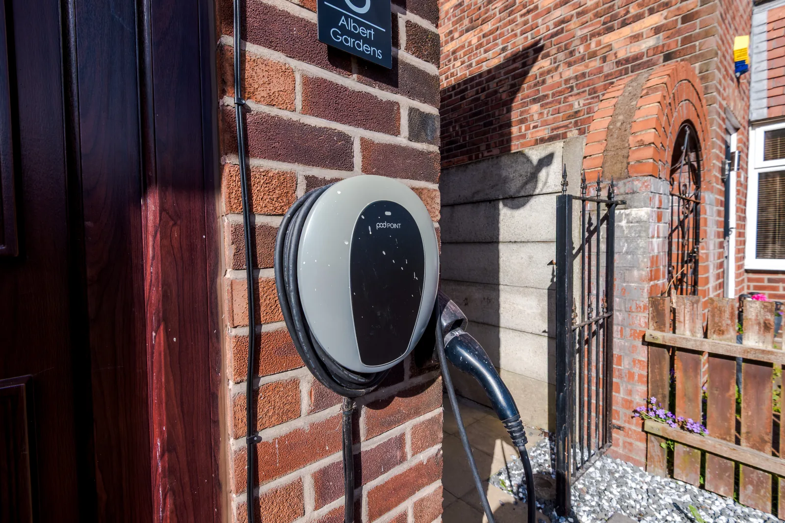An EV charging point mounted beside the front door at 3 Albert Gardens in Newton Heath, Manchester