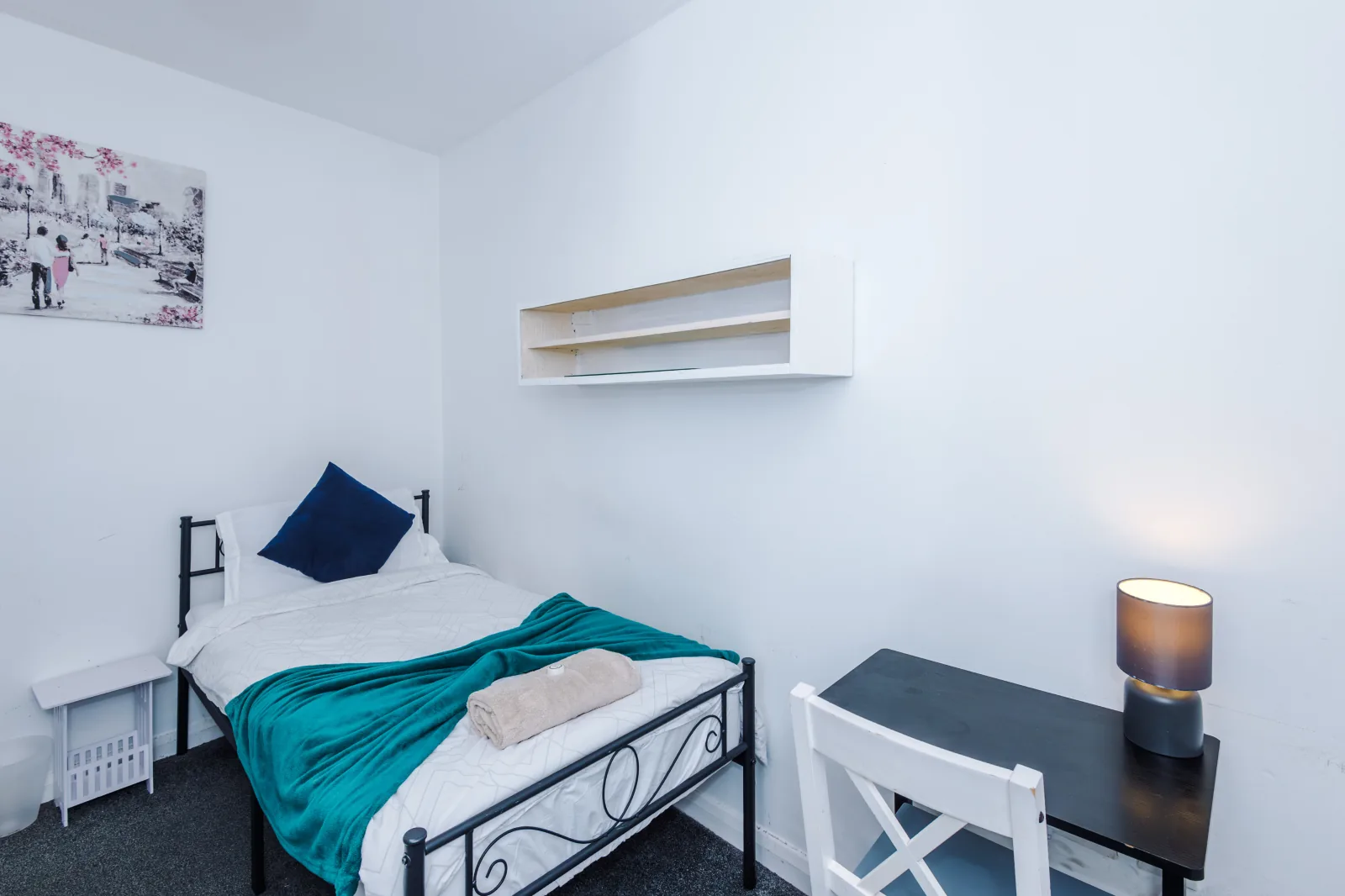 Single bedroom with a desk, shelf and reading lamp at Flat 5, Pendleton Way