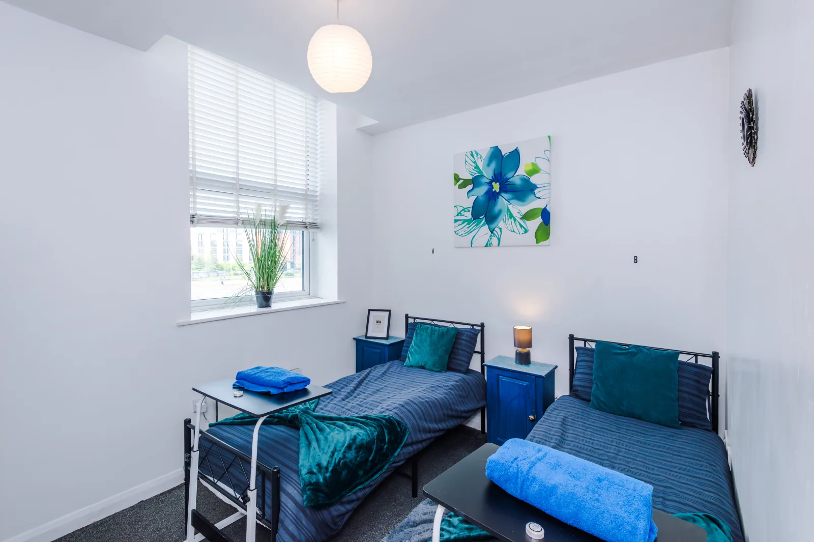 Twin bedroom with two single beds and a window at Flat 5, Pendleton Way