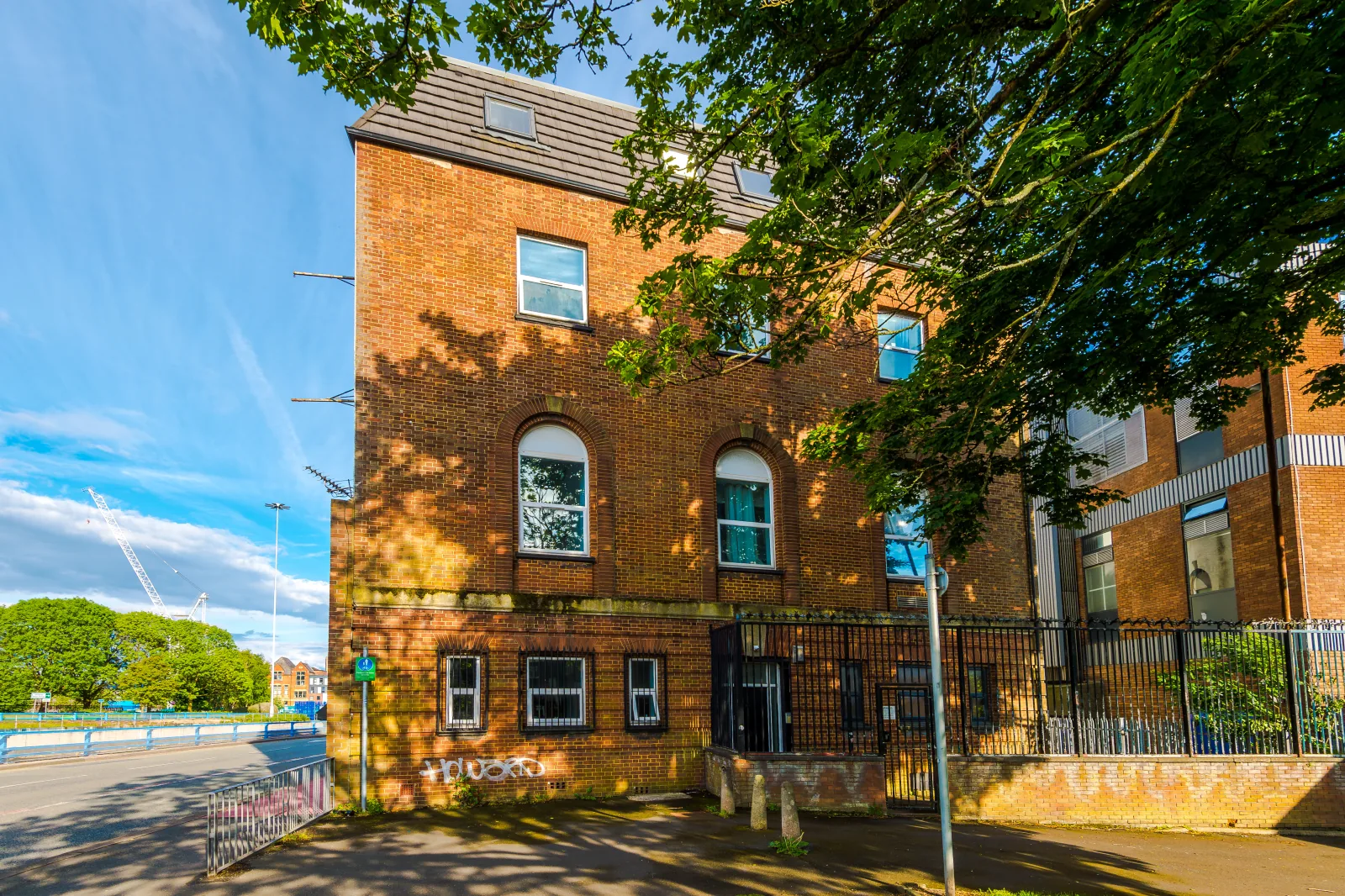 The red-brick exterior of the building housing Flat 5, Pendleton Way in Pendleton, Salford