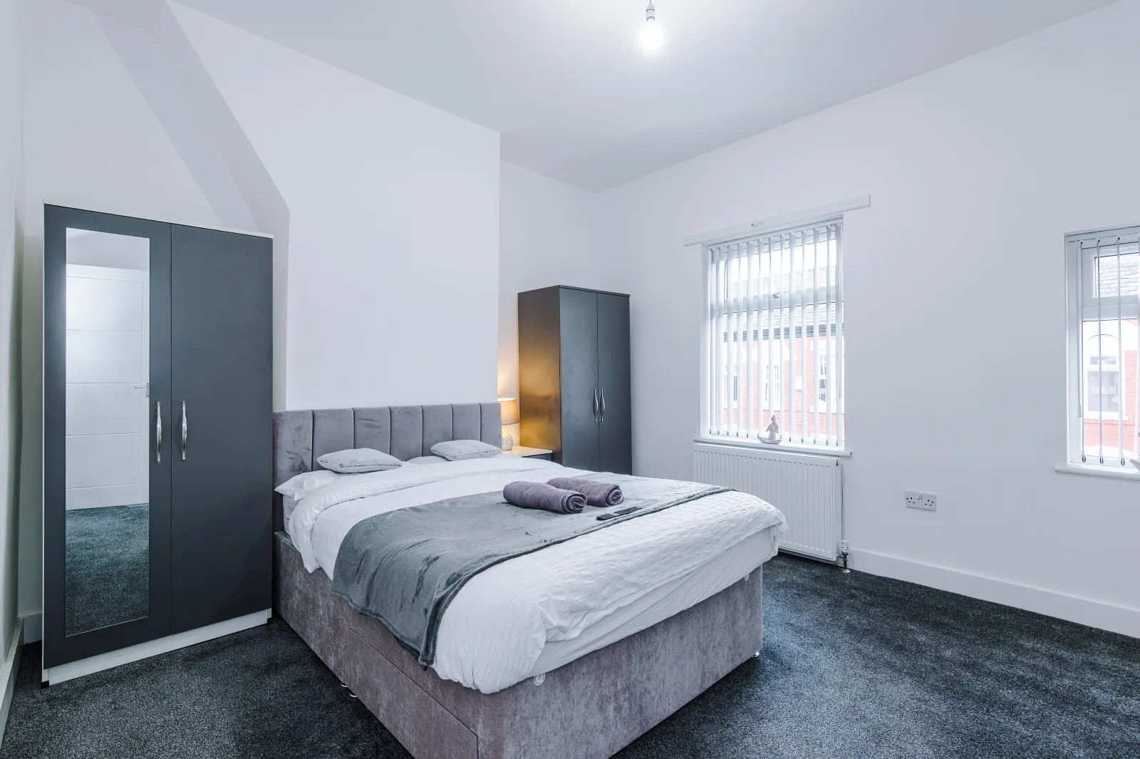 Main double bedroom with fitted wardrobes and two windows at 34 Beeston Street