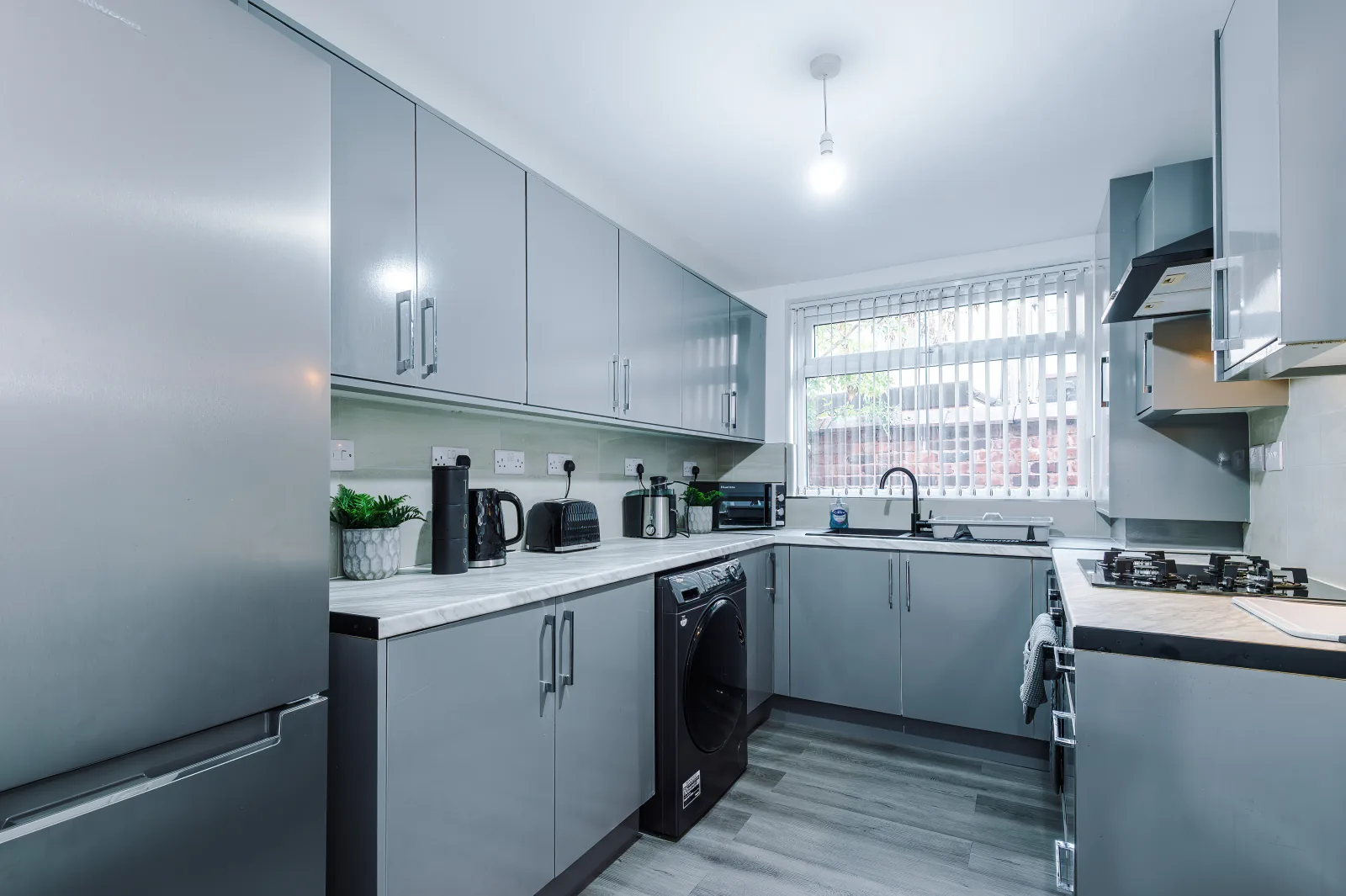 Kitchen from the doorway, with washing machine and window over the sink at 34 Beeston Street