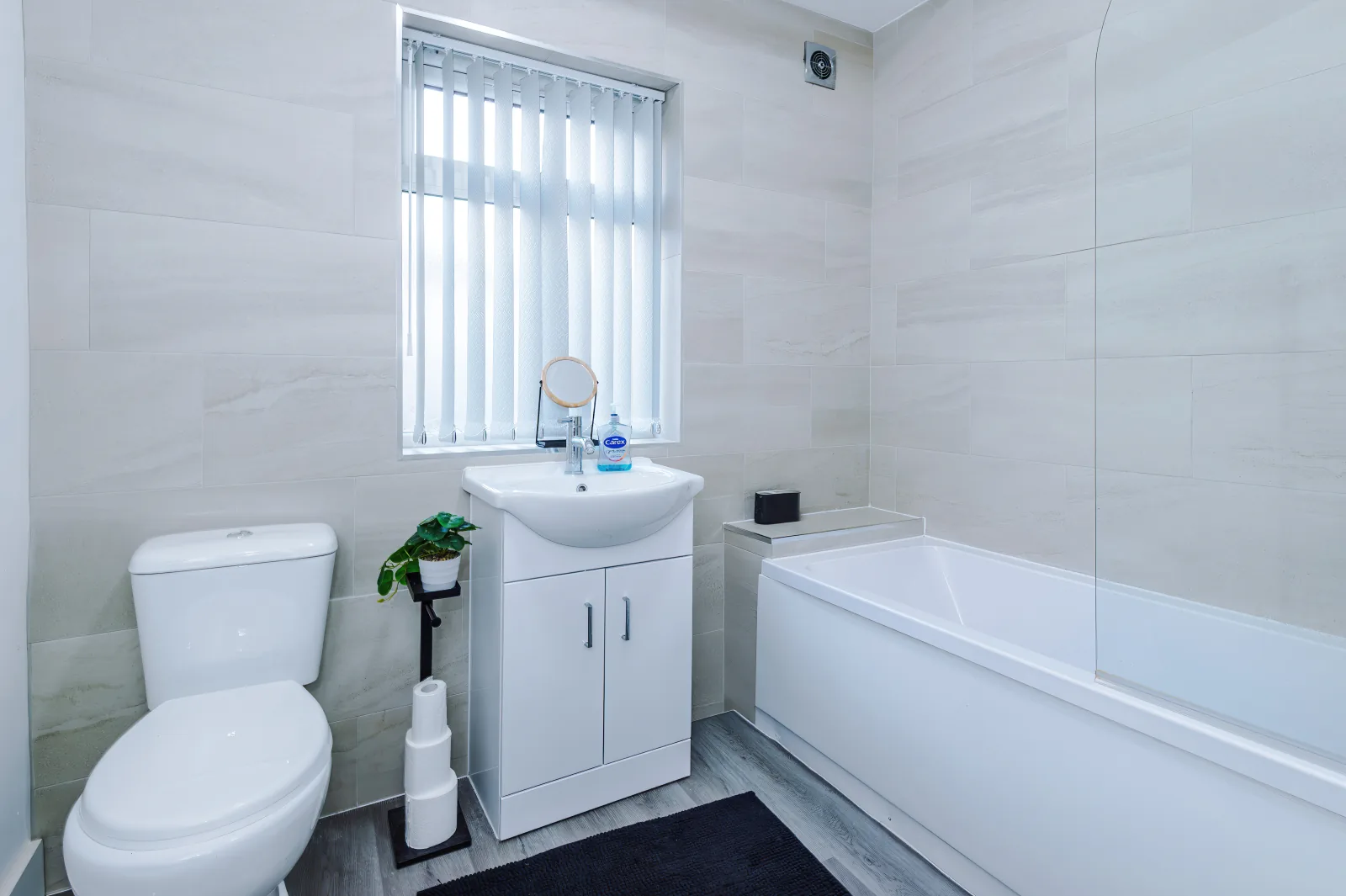 Bathroom with a full-size bath, basin and window at 34 Beeston Street