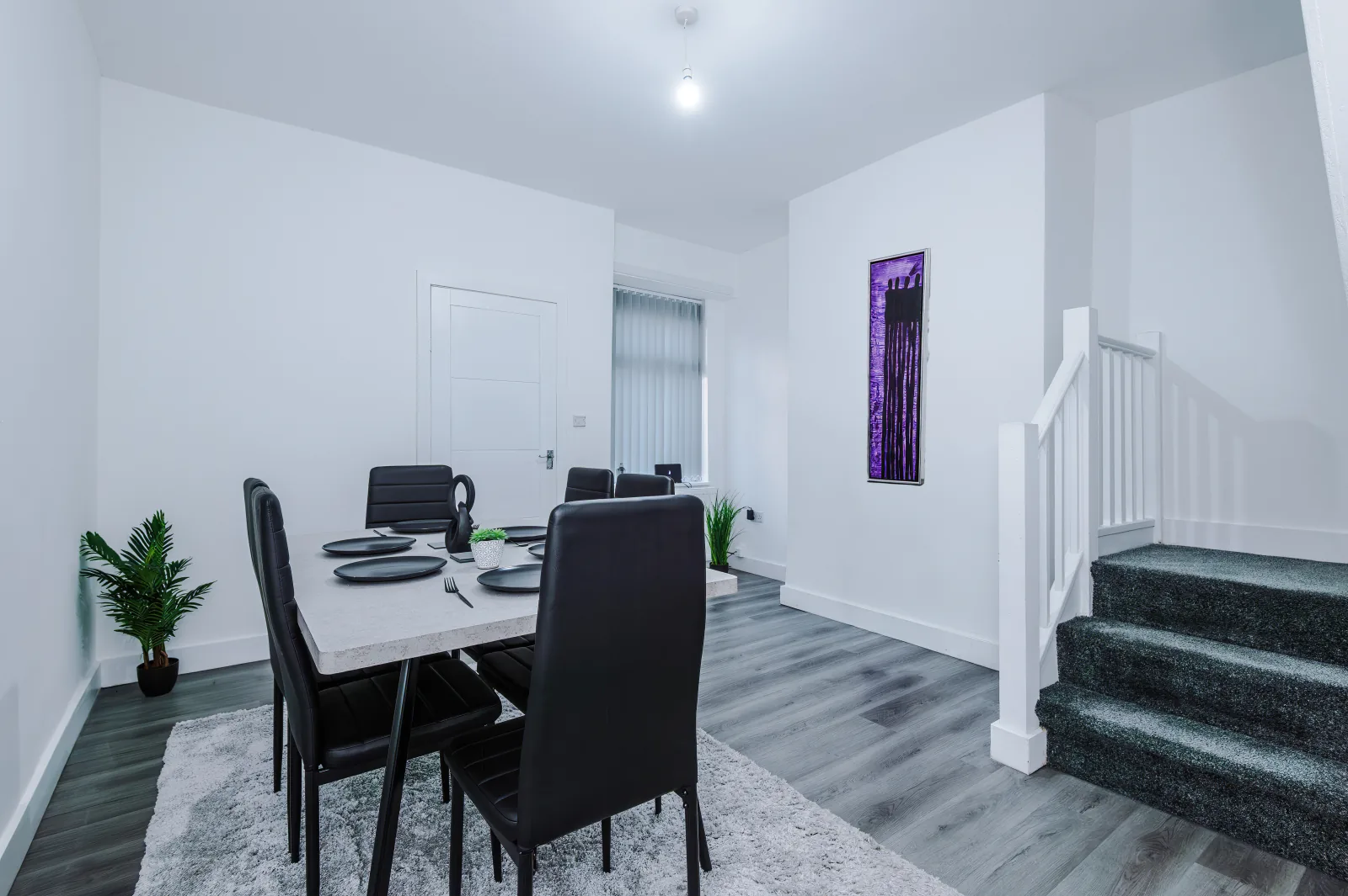 Dining area with a table for four beside the stairs at 34 Beeston Street