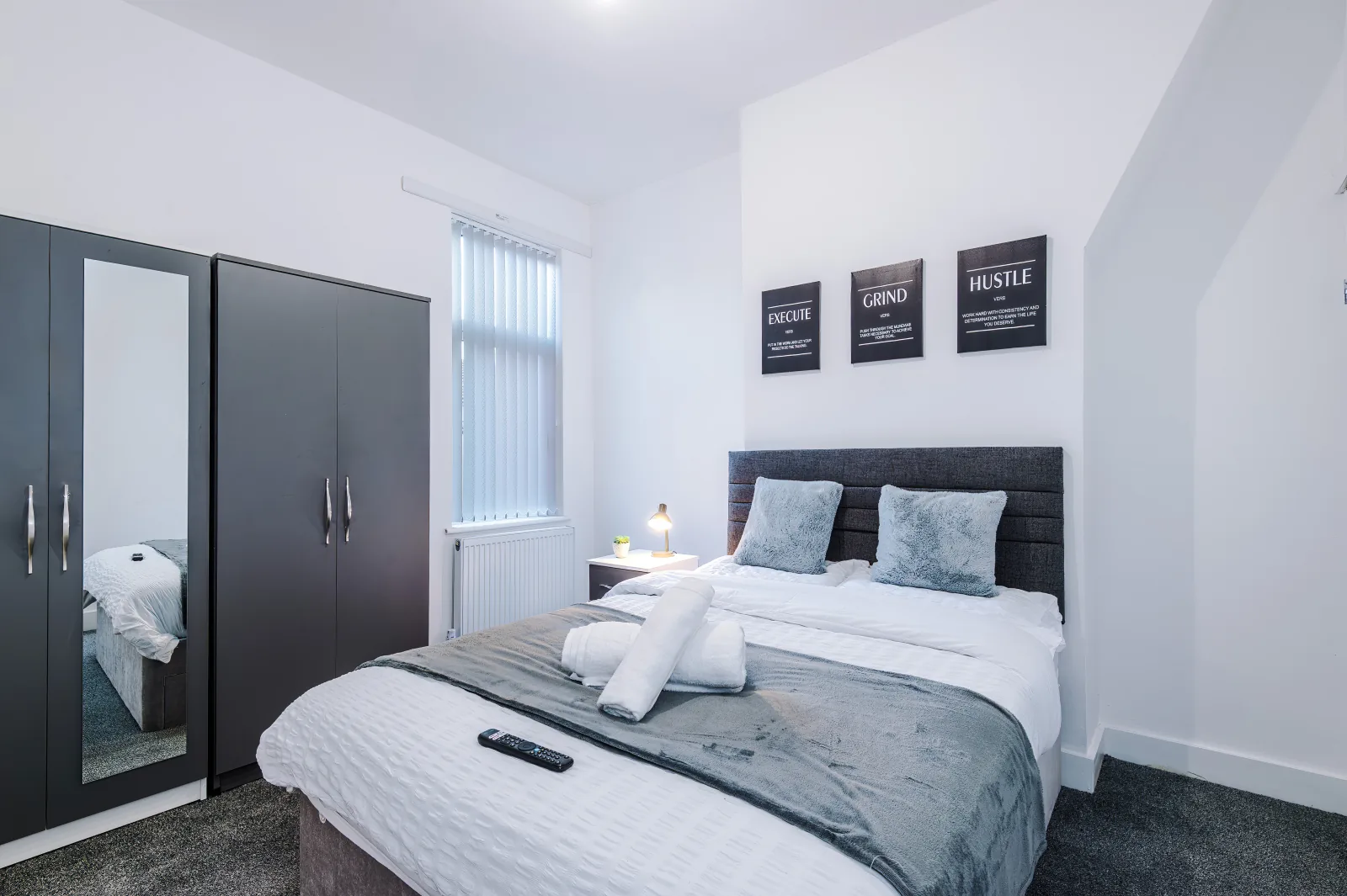 Second double bedroom with wardrobes and framed prints at 34 Beeston Street