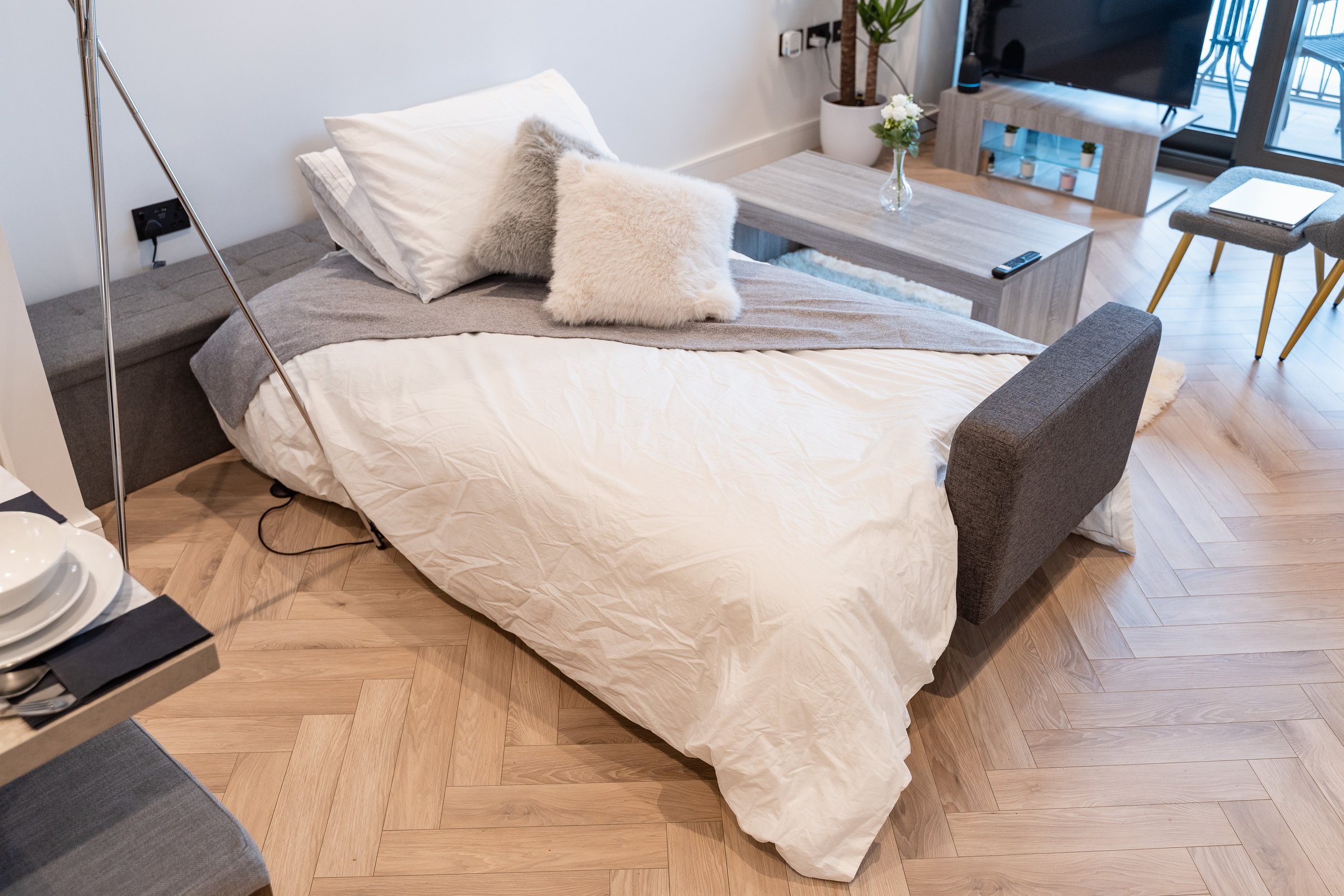 Sofa bed made up with pillows in the living room